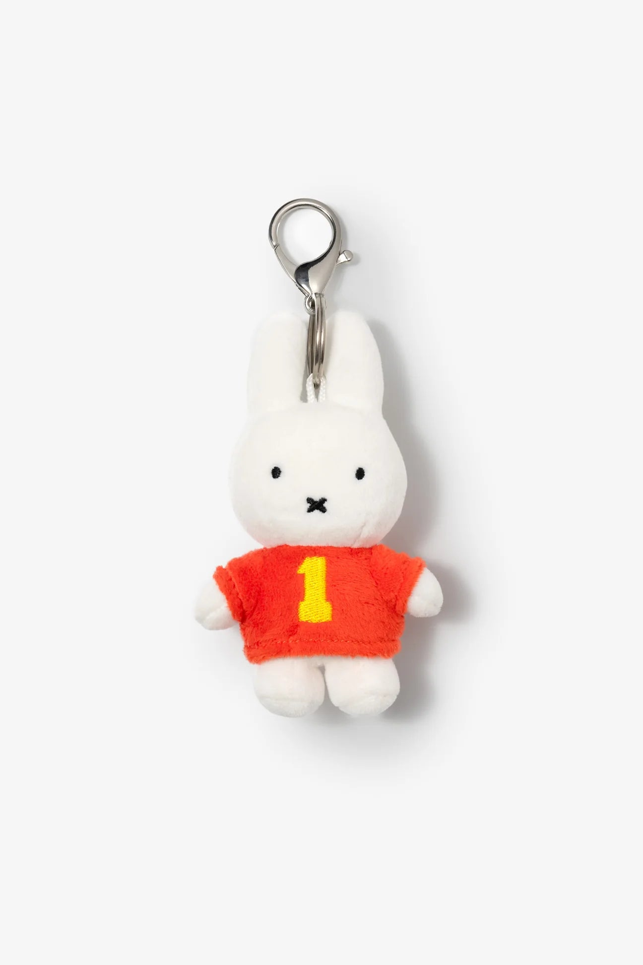 Smoko Miffy #1 Bag Charm: A plush key-chain of a white bunny in a red/orange sweater with a 1, attached to a silver clip.
