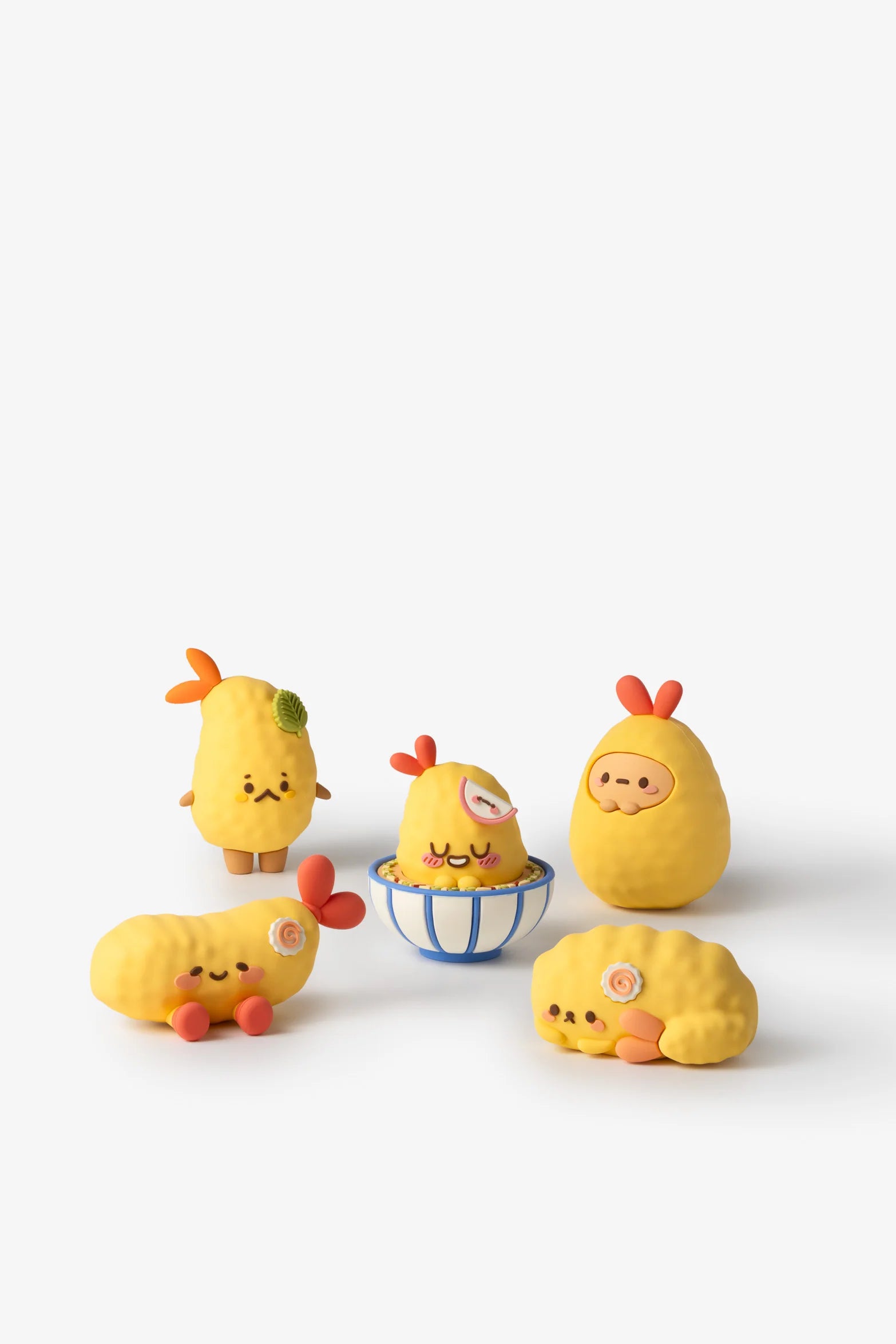 Five Smoko Tempura Shrimpie Blind Box Figures, styled as cute fried shrimp with unique expressions, surround a bowl; collectible, vinyl, and each sold separately.