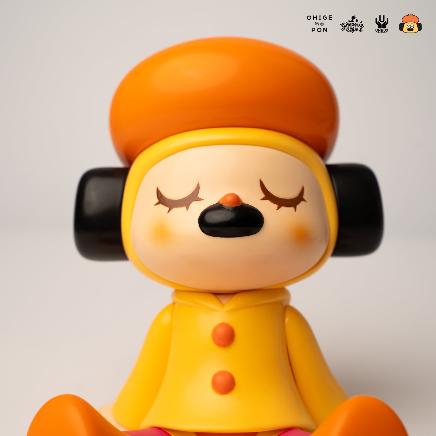 GREENIE OHIGEnoPON EDITION - Preorder: Soft vinyl figure with orange cap, black ear pieces, sleepy expression, yellow coat, and bright shoes. Part of a collectible series.