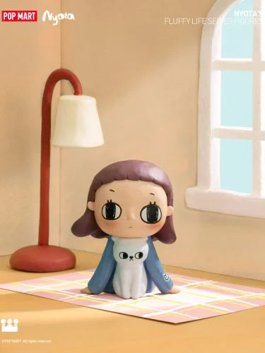 Nyota's Fluffy Life Blind Box Series figurine of a girl sitting on a rug, preorder for July 2024, featuring 12 designs and 1 secret.