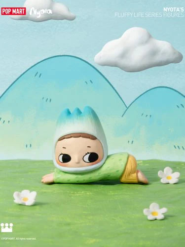 Alt text: Nyota's Fluffy Life Blind Box Series toy doll lying on grass, available for preorder, ships July 2024.
