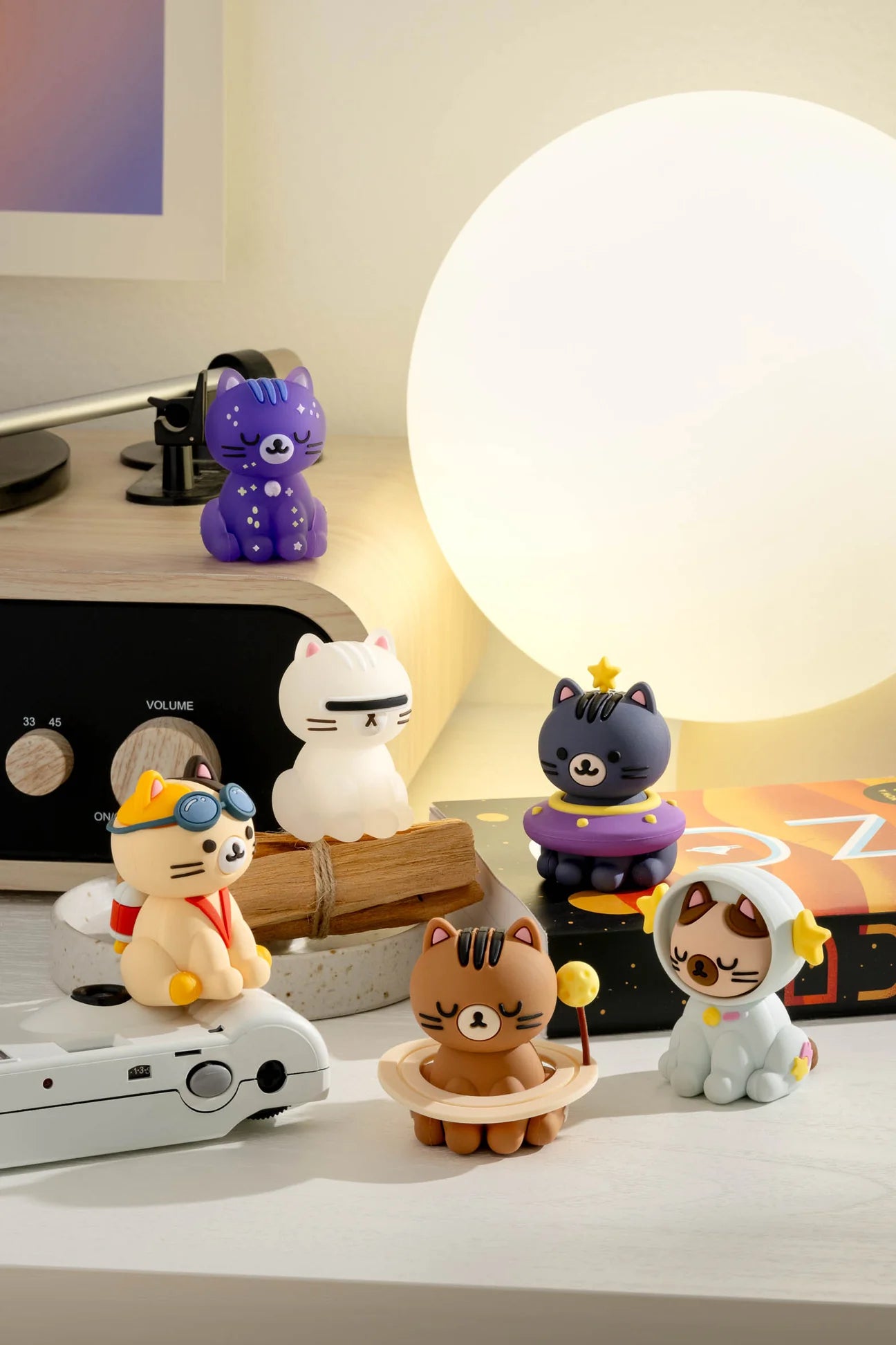 Smoko Astro Cats Blind Box Figure display with space-themed cat figurines. Collectible surprise figures, some glow in the dark, on a styled shelf.