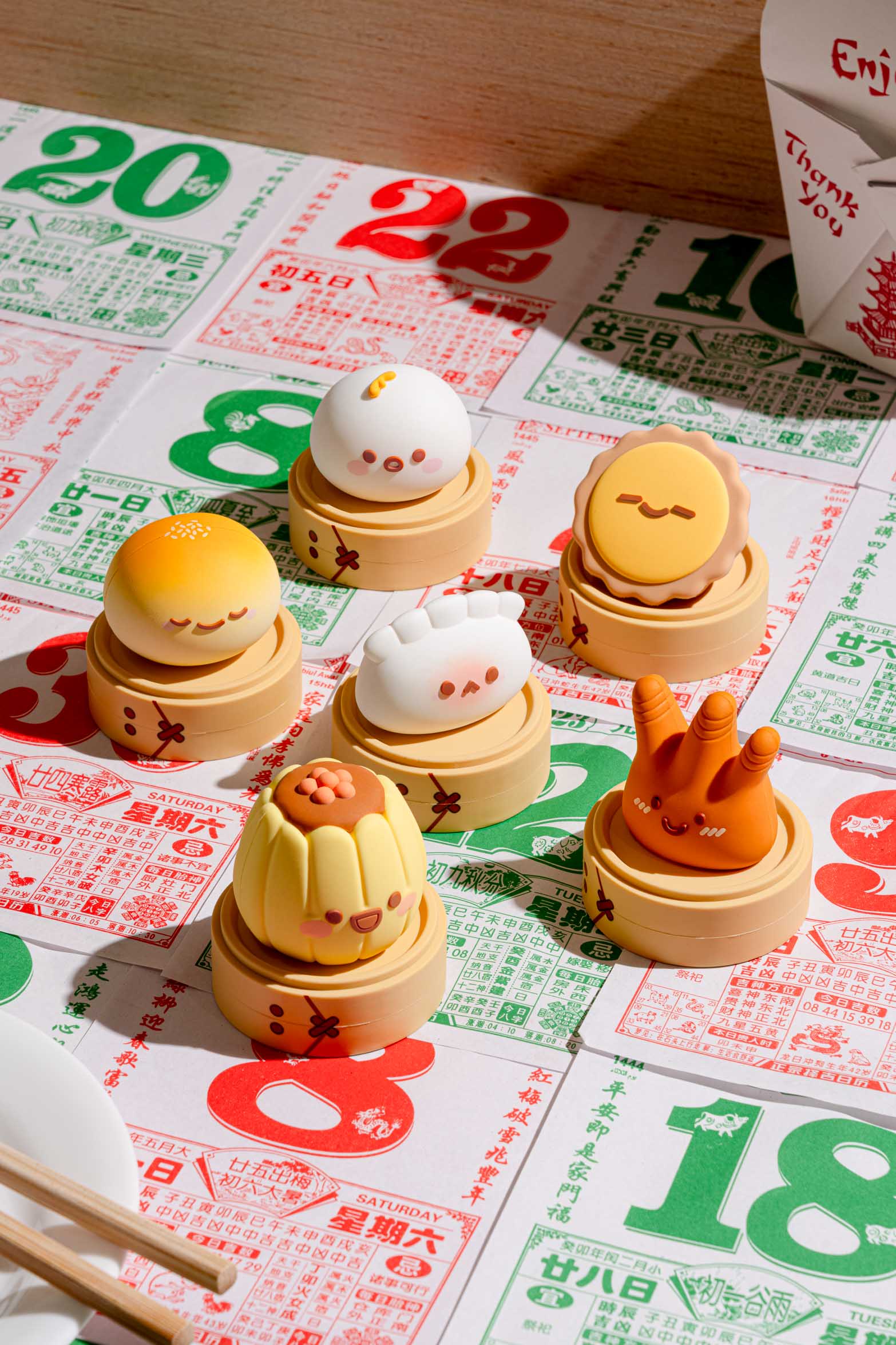 Smoko Dim Sum Friends Blind Box Figure set on a Chinese calendar backdrop, featuring six cute vinyl dim sum figurines with varied expressions.