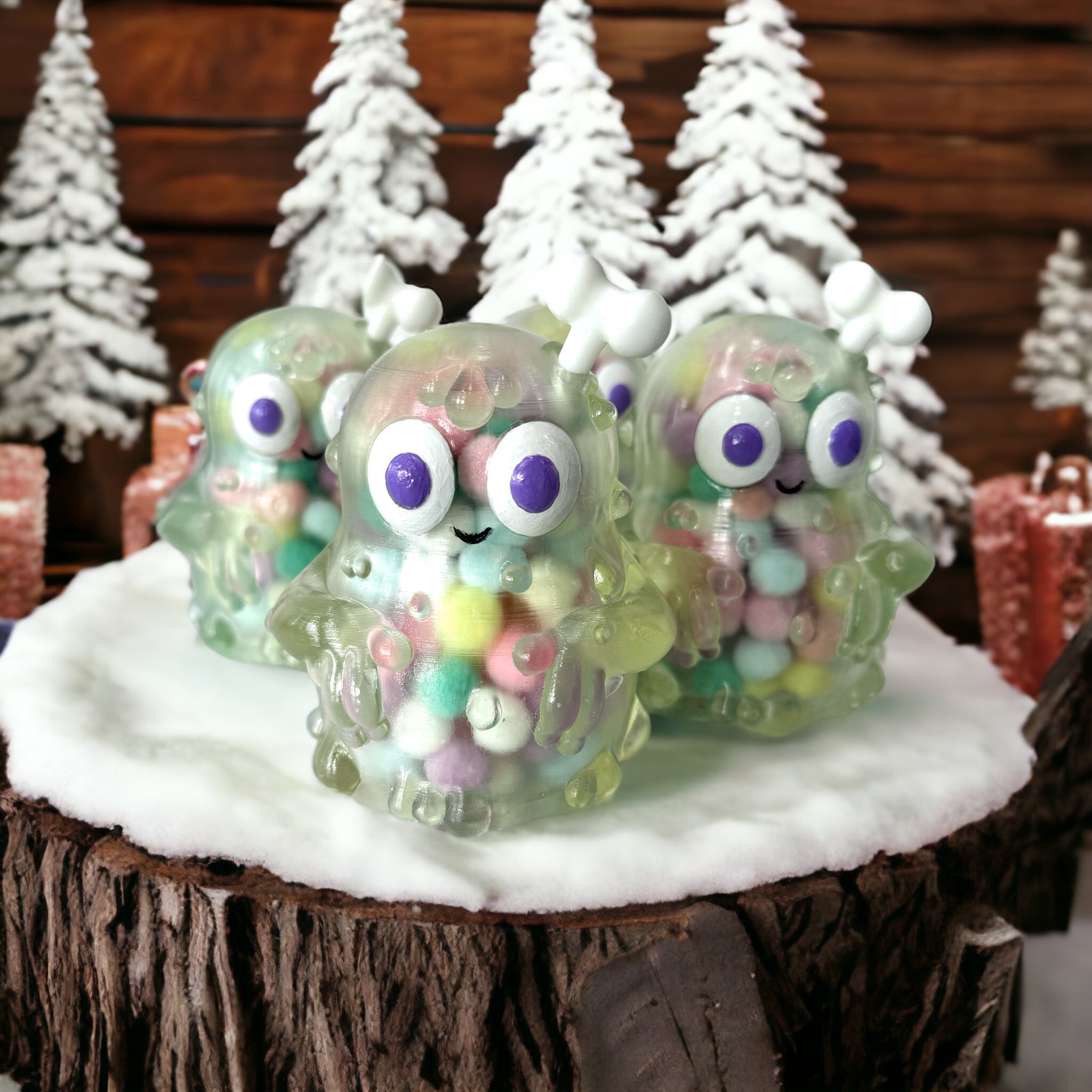 A group of small plastic monsters and balls with snow on a tree stump, close-ups of toys, jelly monsters, and objects, including a purple circle and a blurry red object.
