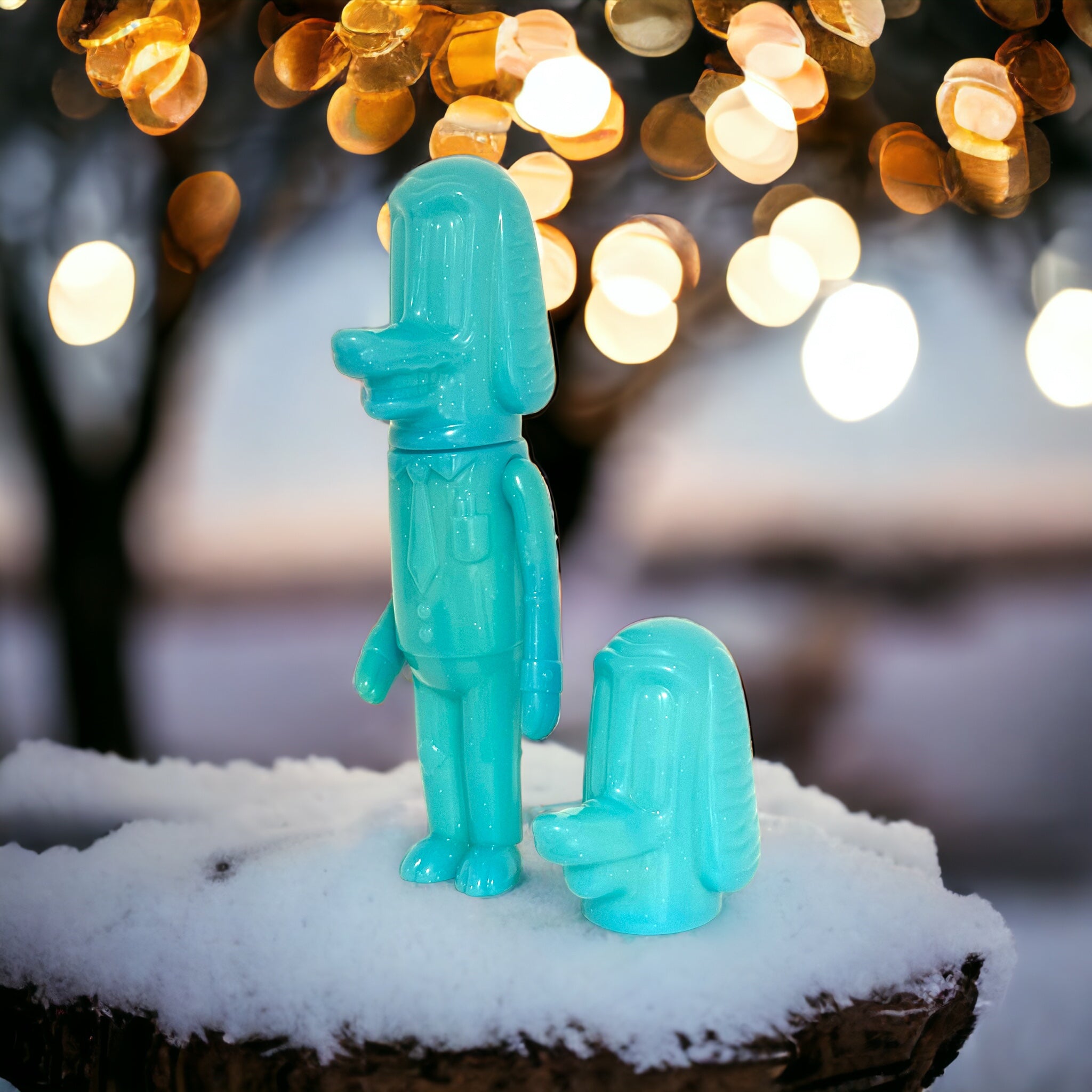 Blue toy figure with tie on stump, snow, slime animal shape, plastic toys, egg, ice, glass lemon - Clear With Stuff Inside - Glow Dog by Vincent Scala.