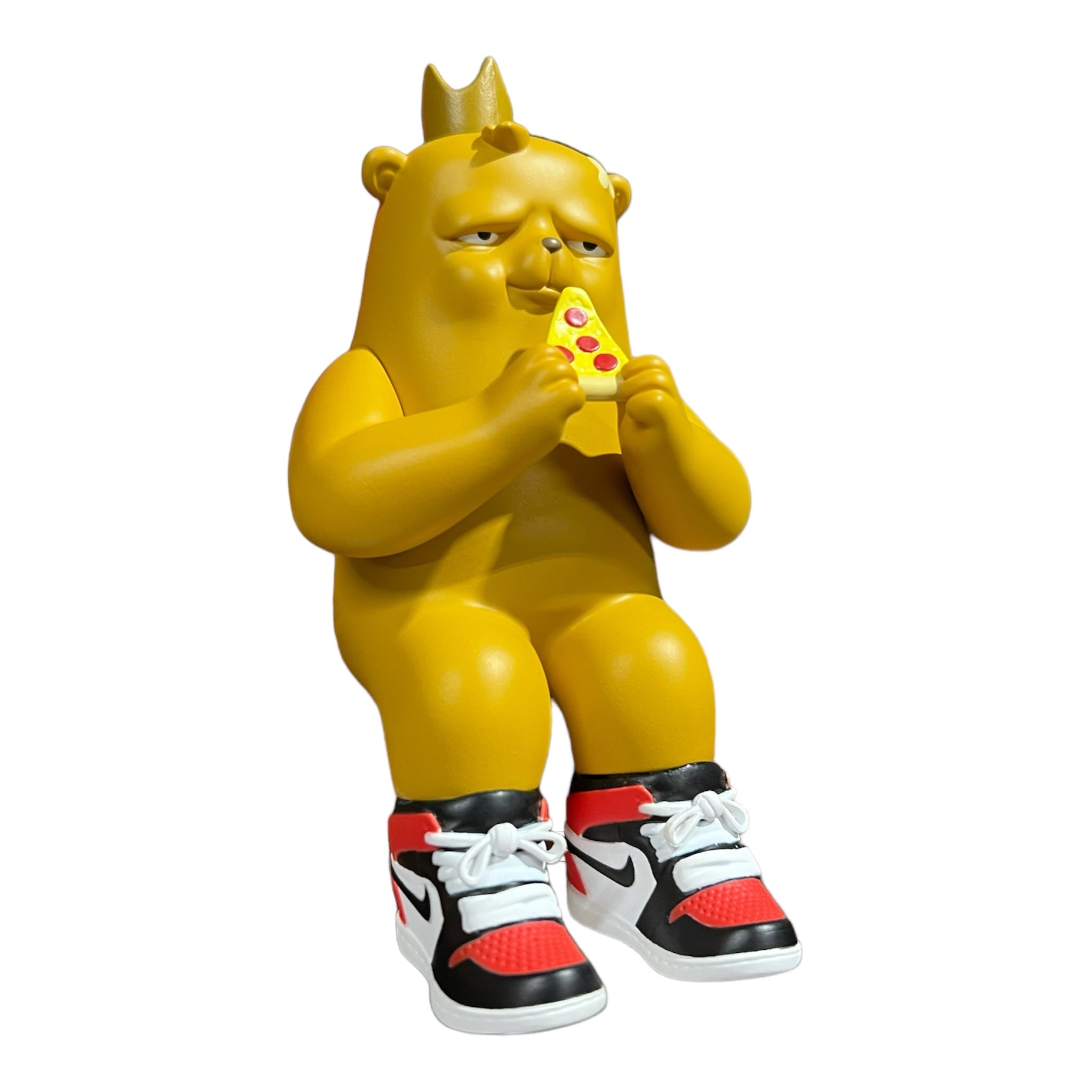 Chunky Boy The Bear Champ Vinyl by JC Rivera, a yellow figurine with a crown and pizza slice, designed for shelf display.