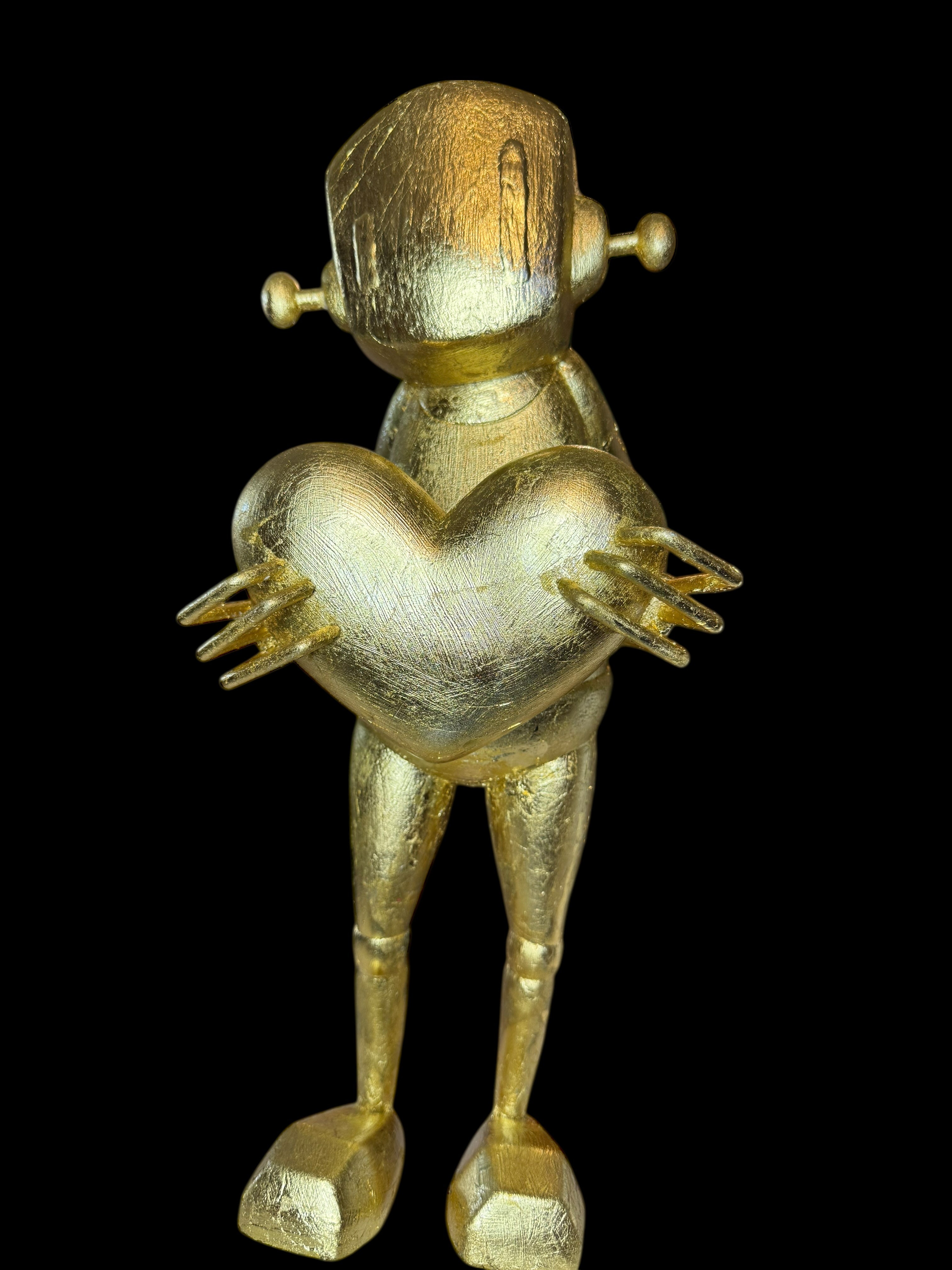 Time Will Tell - 'False idle' by Chris RWK: A 15-inch gold-plated vinyl robot figurine holding a heart, reflecting Strangecat Toys' artful, abstract designs.