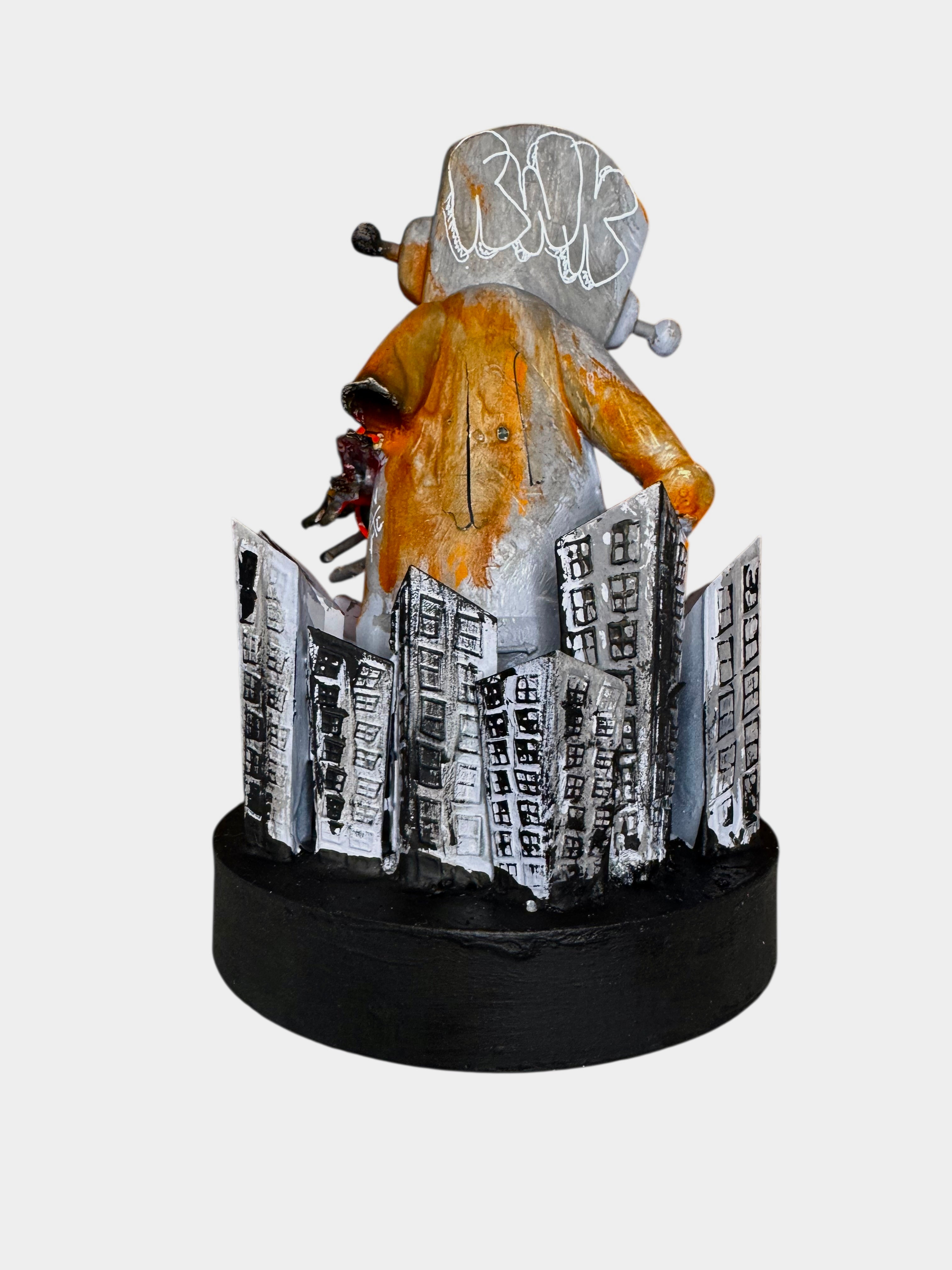 Time Will Tell - Still standing by Chris RWK: A 6.5 mixed media sculpture featuring a TV-headed figure on a cityscape base.