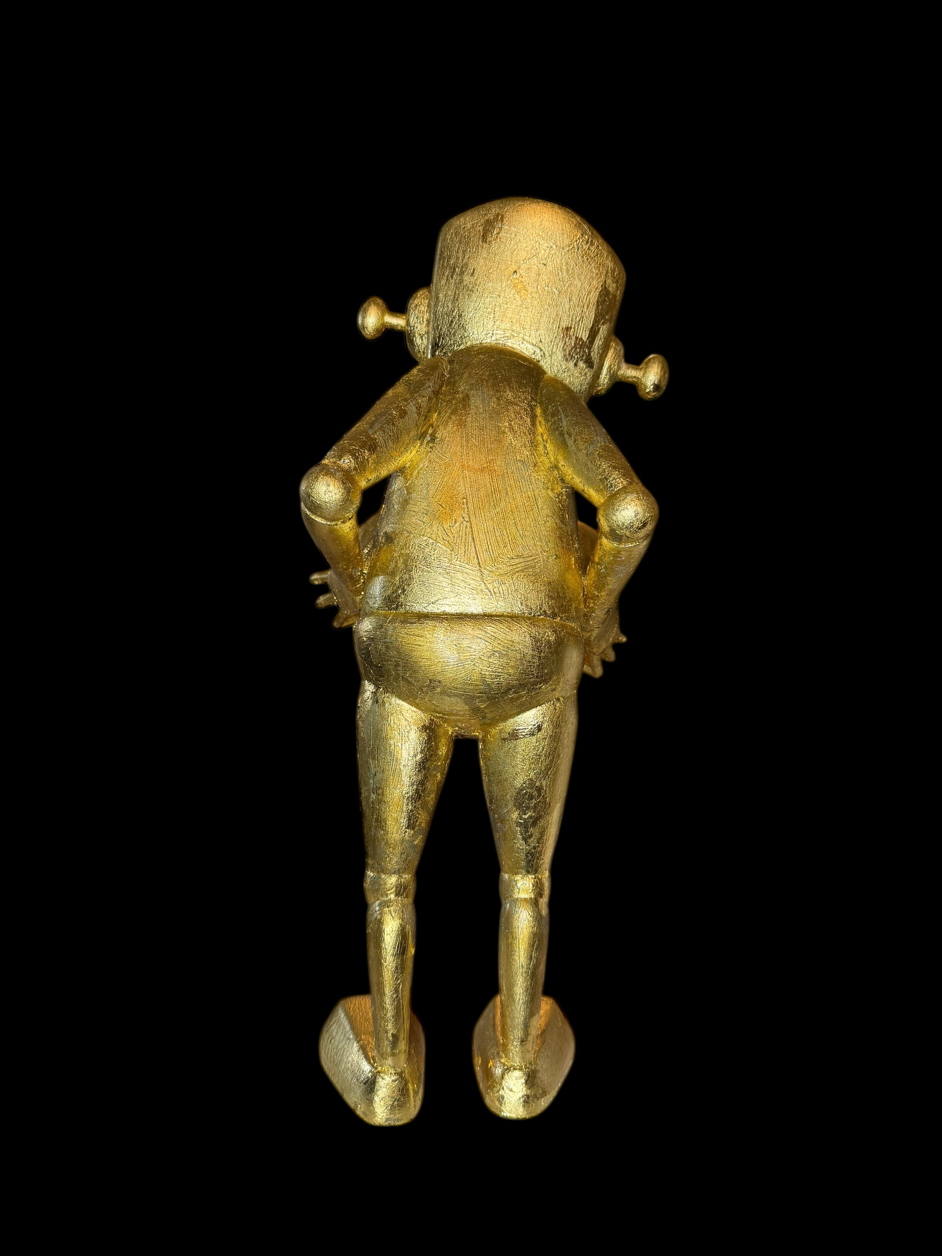 Time Will Tell - False Idle by Chris RWK: 15 gold-painted vinyl figurine with textured surface, robotic design, hands on hips, viewed from behind.