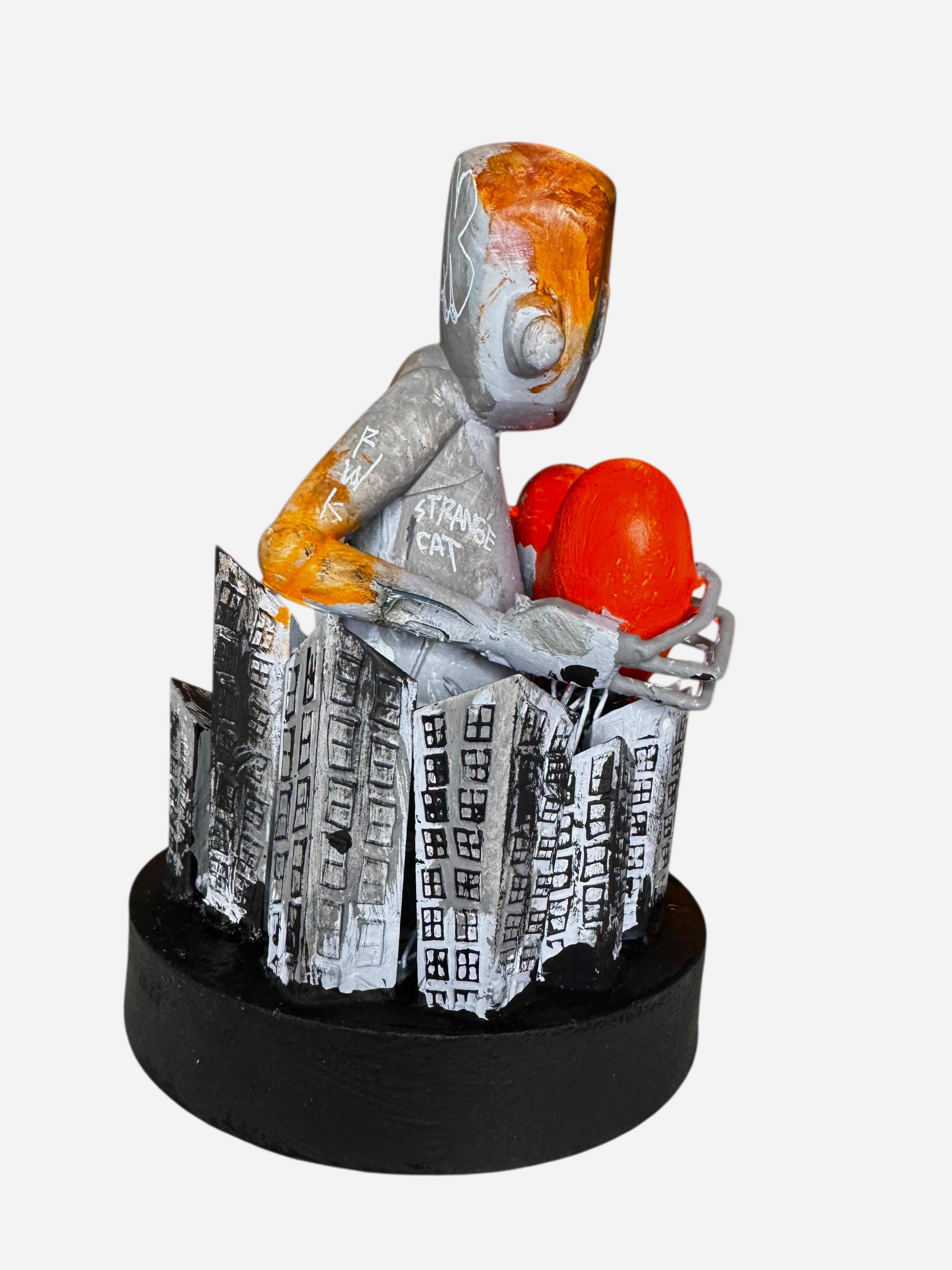 Time Will Tell - Still Standing by Chris RWK: A 6.5 resin sculpture of a silver robot with red forms, encircled by jagged cityscape cutouts.