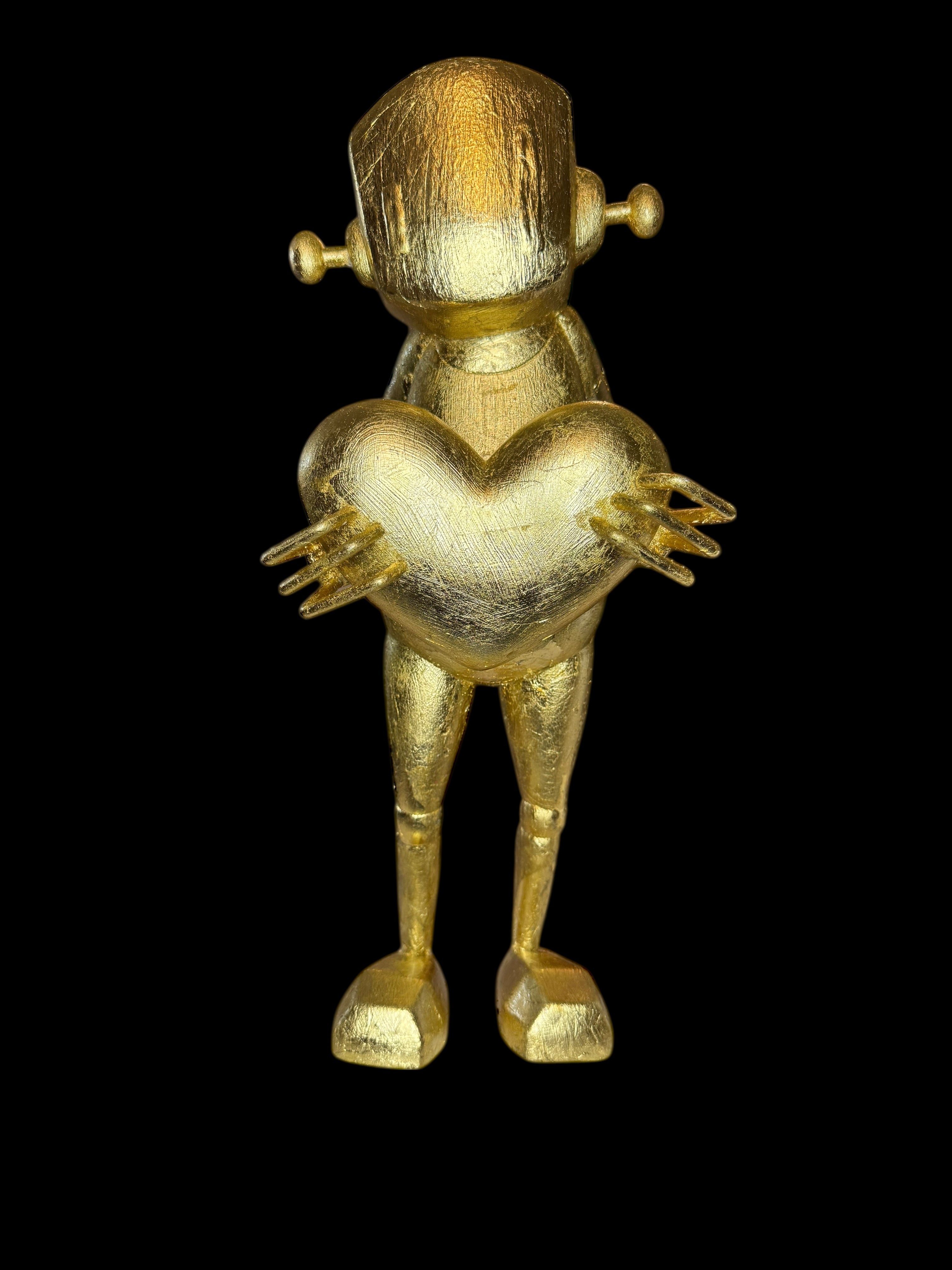 Time Will Tell - False idle by Chris RWK: A 15 gold vinyl humanoid robot figurine holding a heart, with a brushed metallic finish.