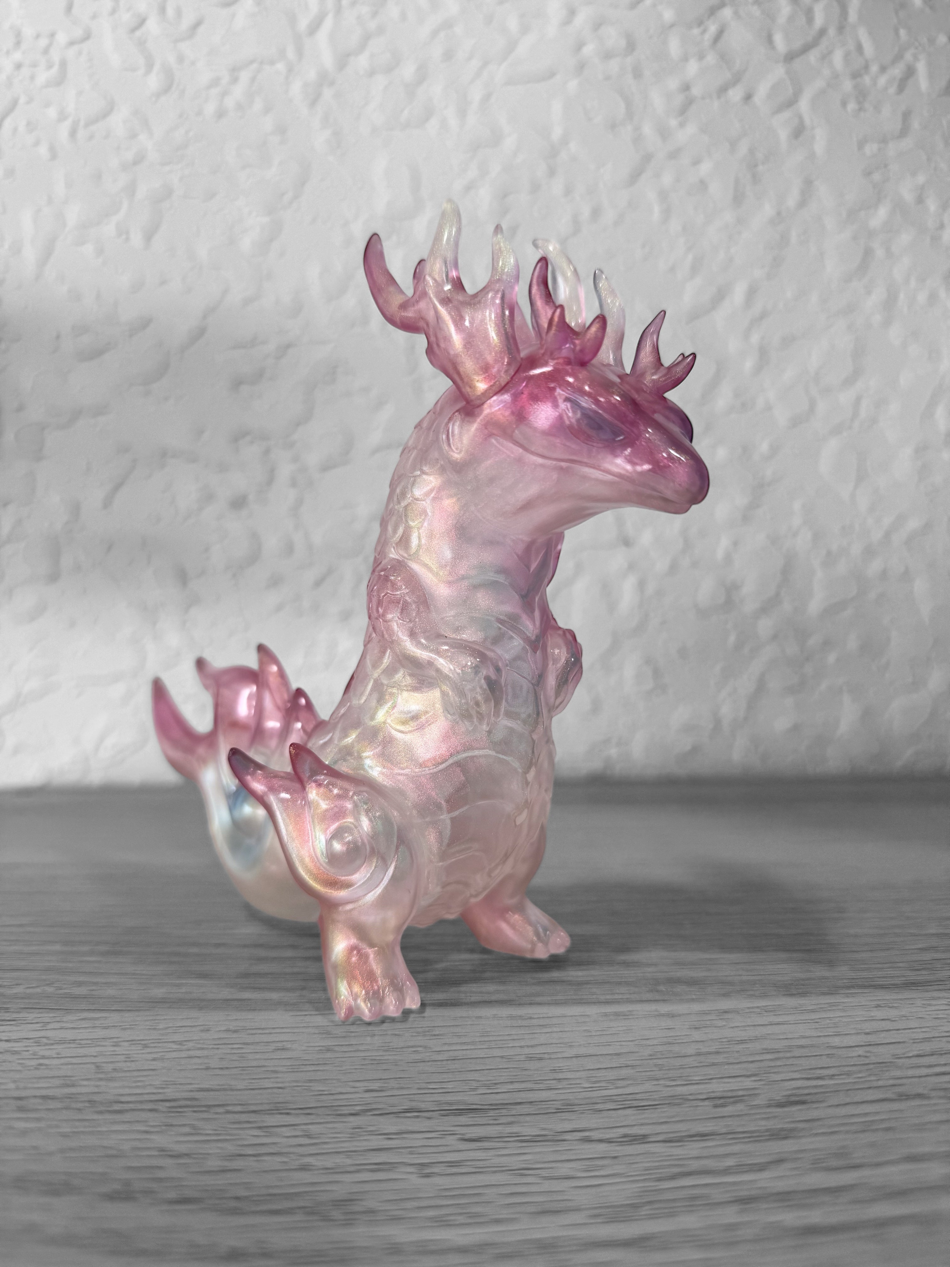 Rinkaku - Soap Bubble Pink by CORE Kashi, a 15cm tall, pink and white dragon figurine crafted in Japanese Soft Vinyl, displayed on a wooden surface.