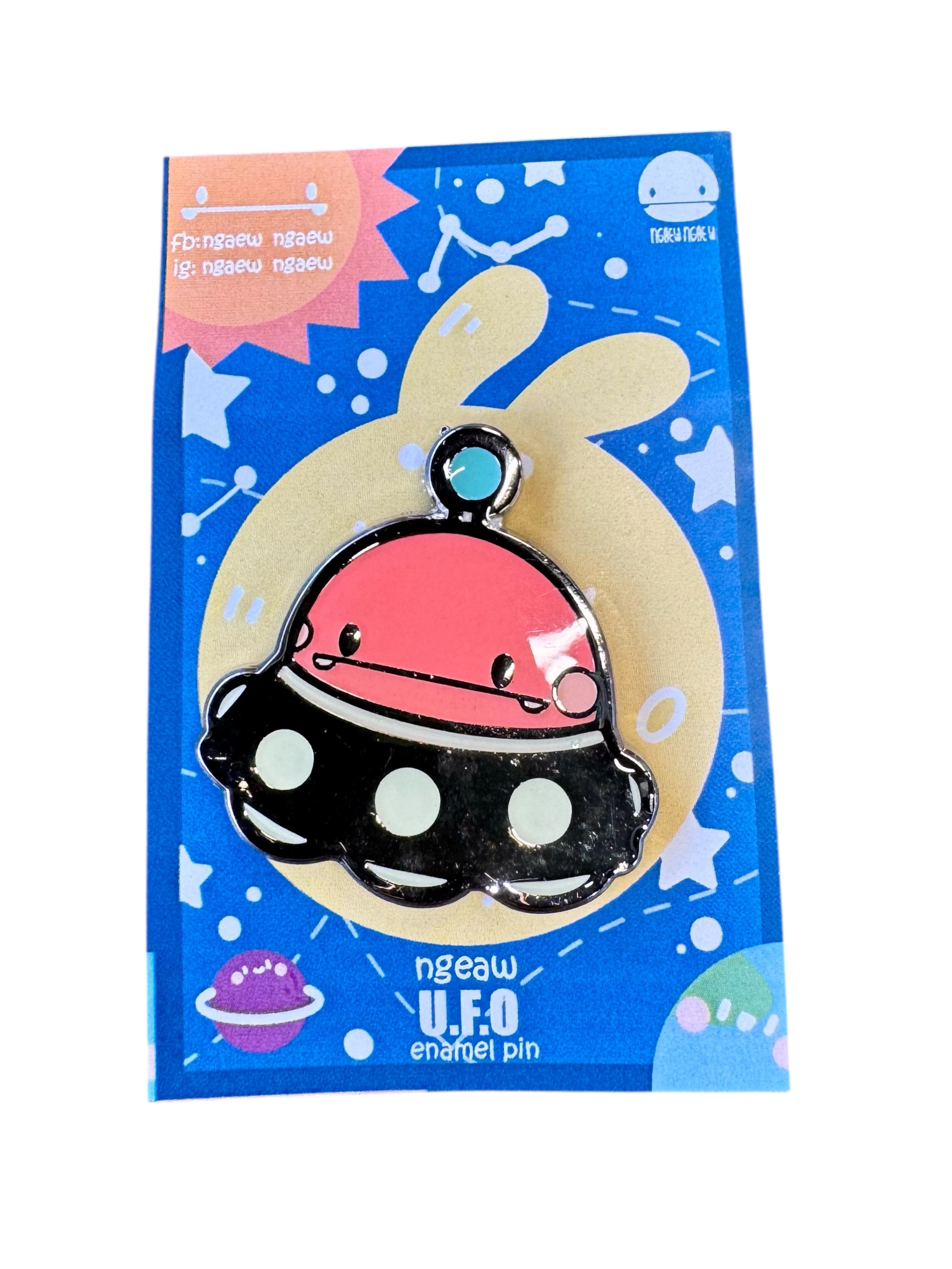 Ngaew Ngaew Red Space Pin featuring a cute pink U.F.O. character on a black saucer, displayed on a themed backing card.