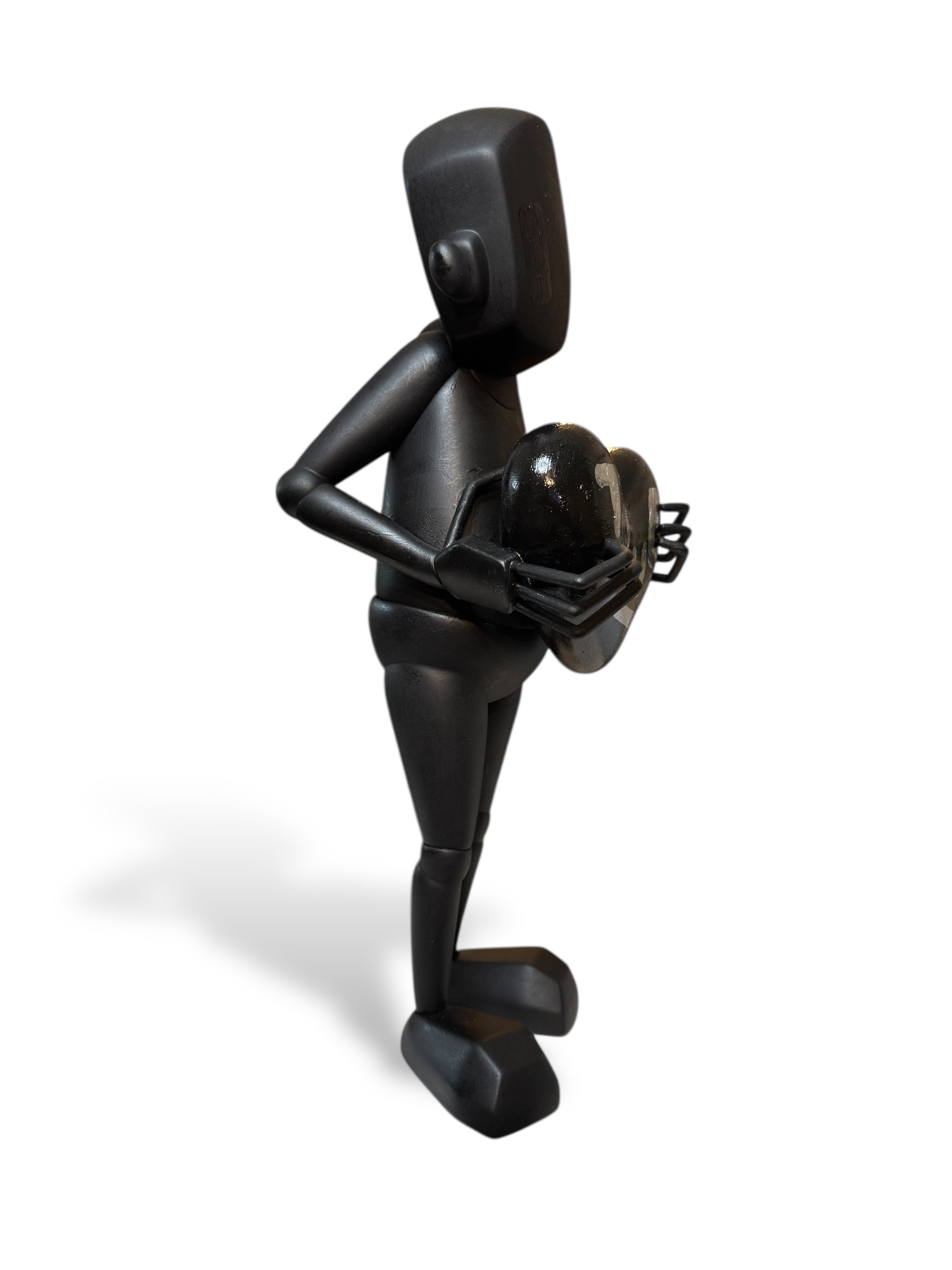 Time Will Tell - 'Midnight Special' by Chris RWK: A 15-inch black vinyl figurine, holding a glossy heart, showcasing abstract, geometric design.