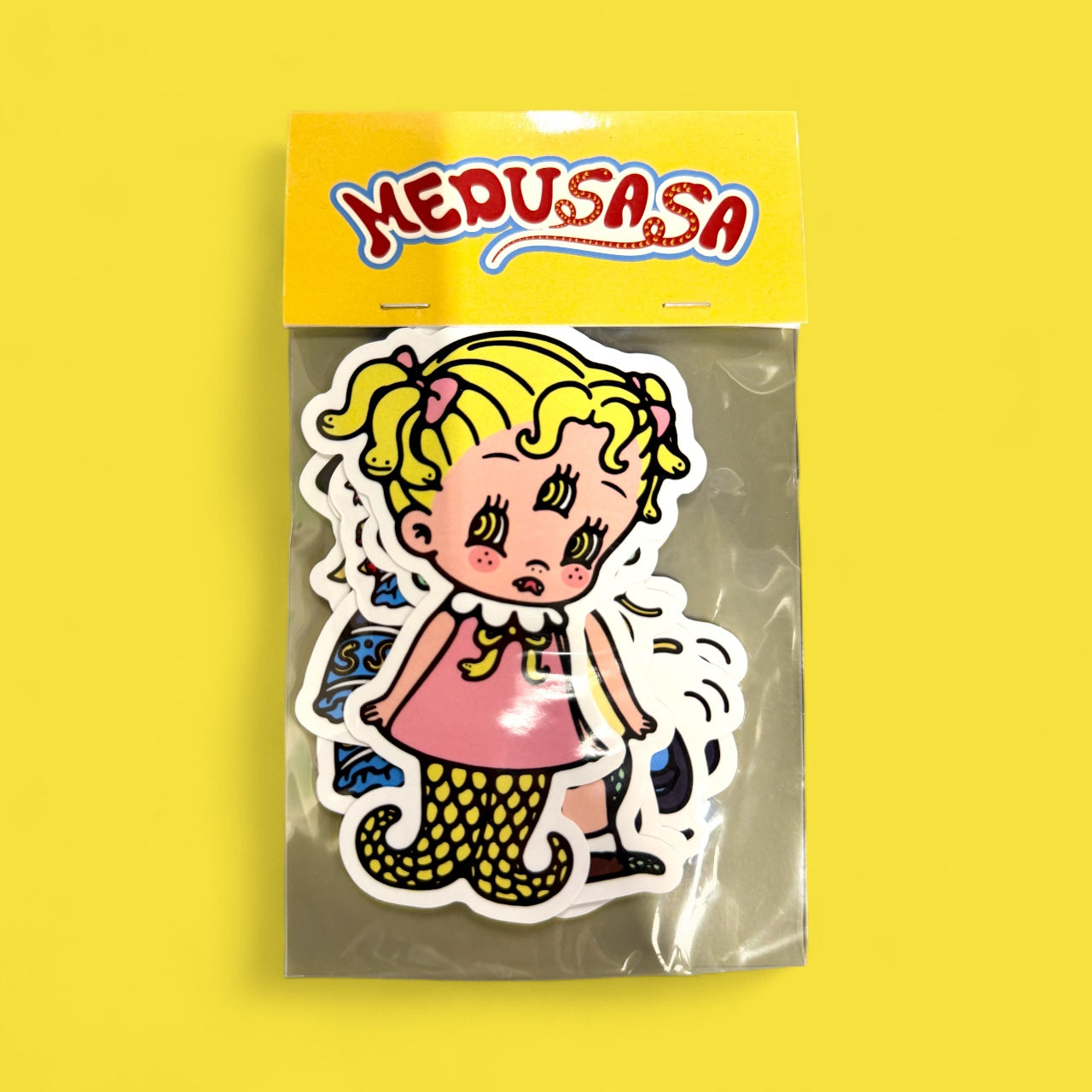 Medusa sticker pack featuring a die-cut vinyl sticker of a cartoon girl with snake-like hair and tentacle legs in pop-art style, 4 size, 6-pack.
