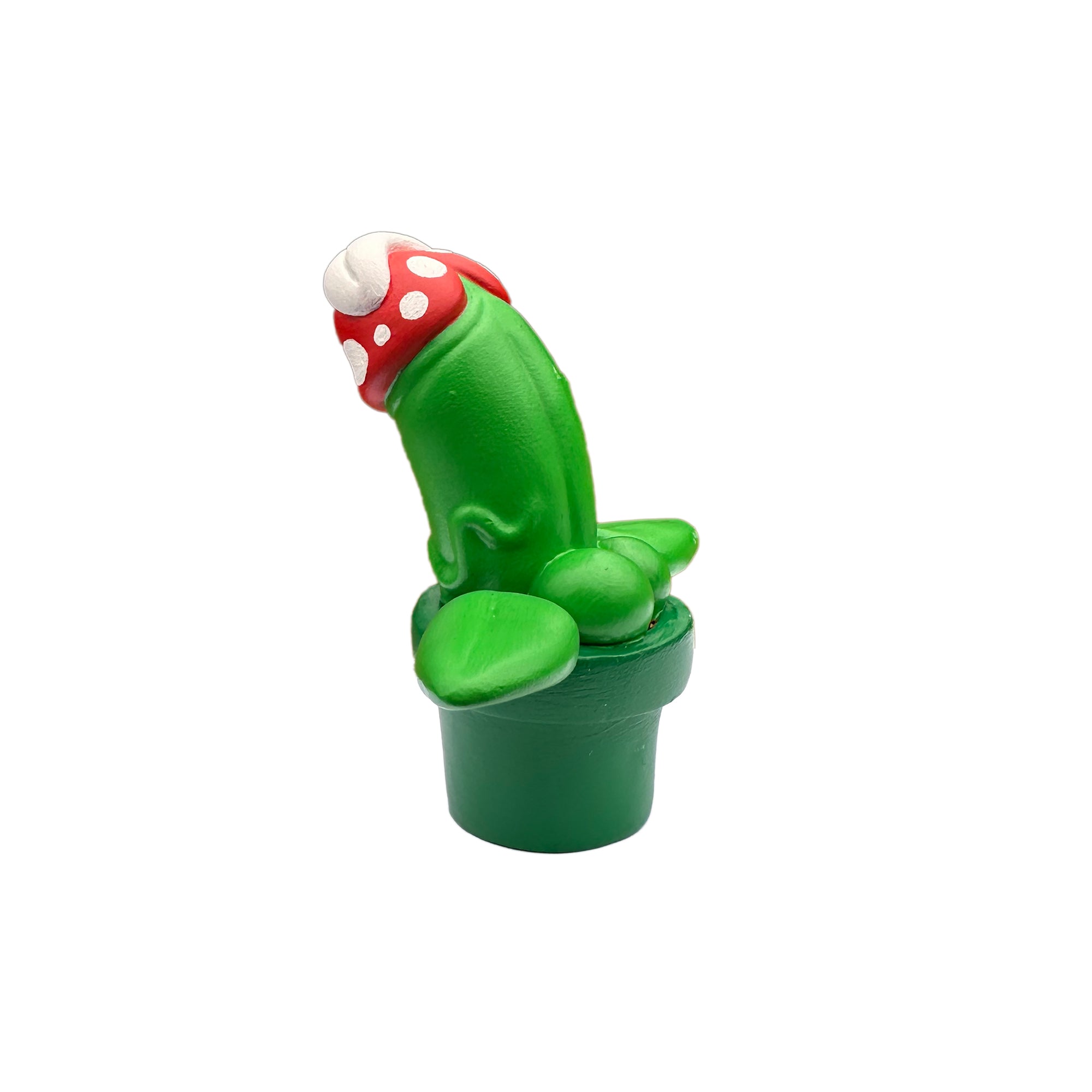 A close-up of a green toy plant with a red hat, part of Simon Says Macy & Friends - Piranha Pecker by Prime.