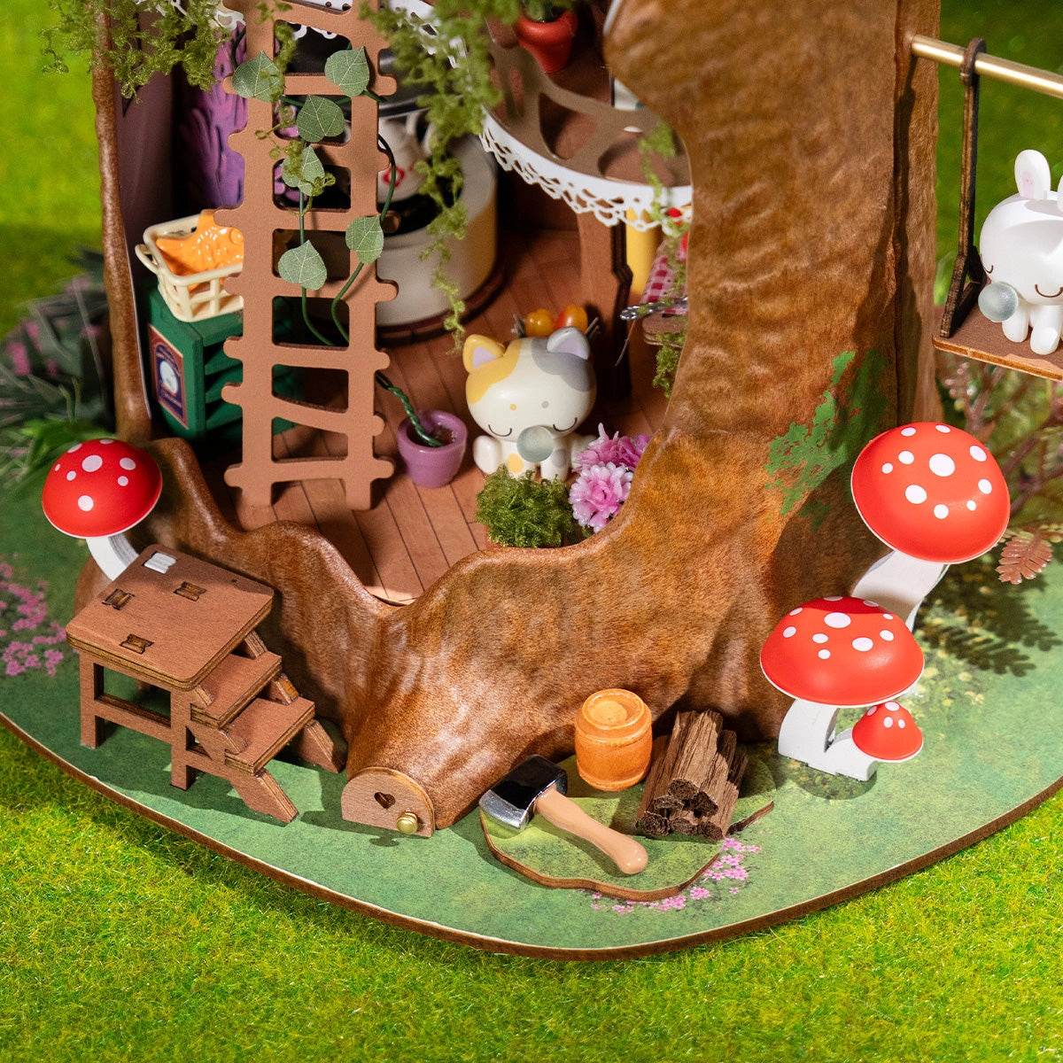 Rolife DIY Miniature House - Fairytale Tree House DG179: A whimsical tree-stump diorama with a ladder, cat, bunny, potted plants, mushrooms, and woodland accessories.