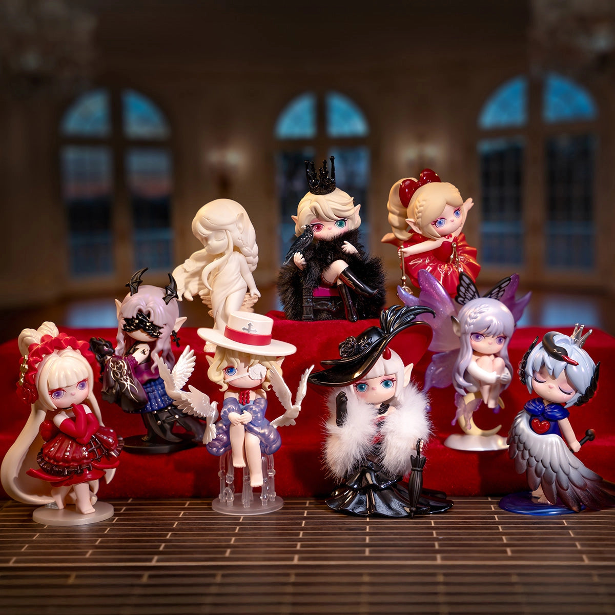 Suri's Mystery Castle Blind Box Series featuring chibi fantasy girl figurines with oversized heads and unique costumes, showcased on red velvet tiers.