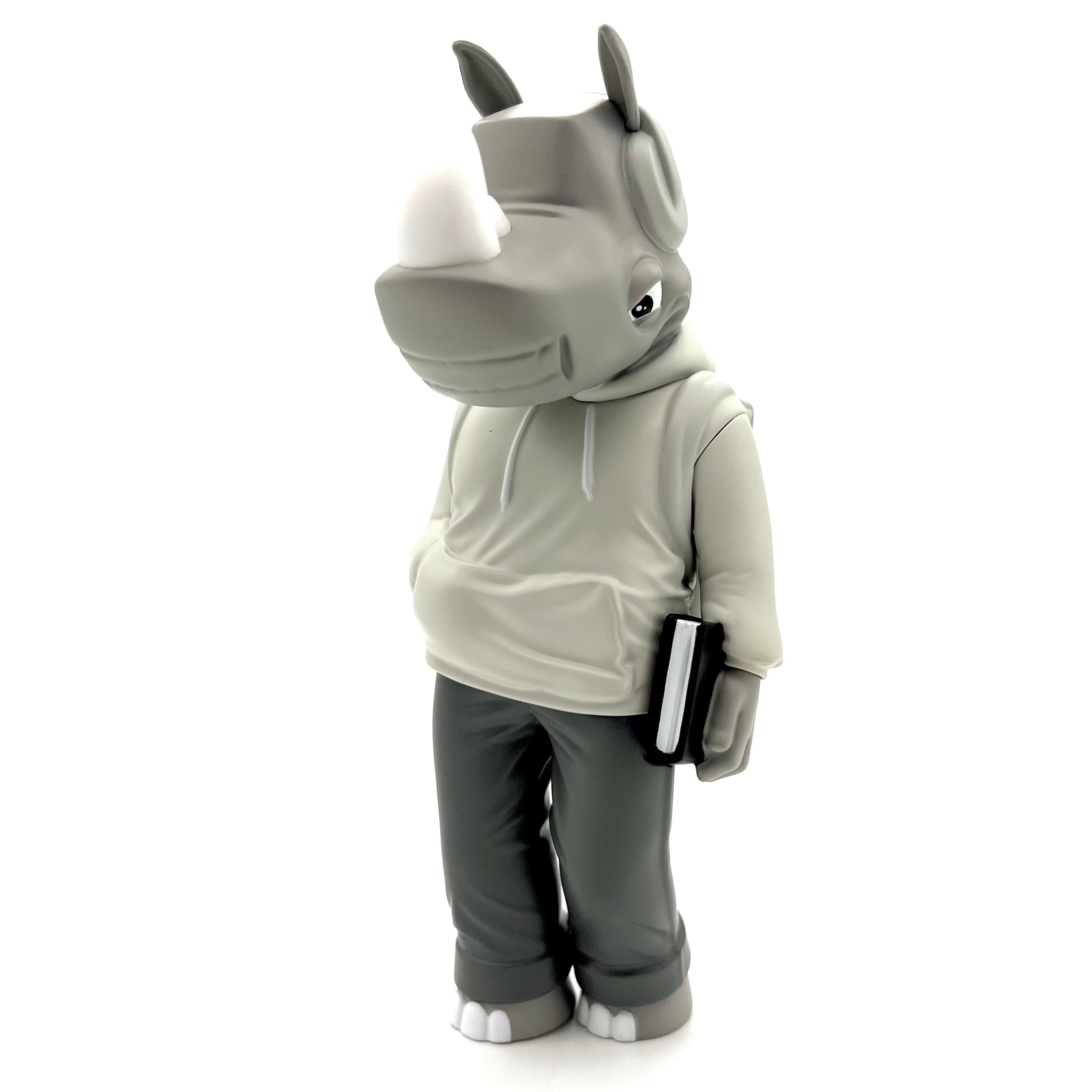 Rumpus Mono Edition by Scribe, a 7 vinyl figure of a rhinoceros in a hoodie holding a book, limited to 150 pieces worldwide.