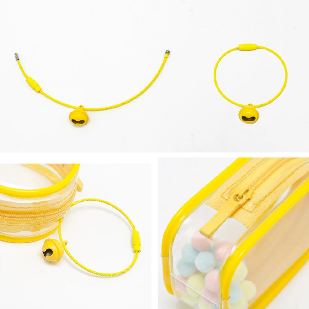 Toy Pochette Keychain: Transparent doll bag with a yellow zipper and smiley face necklace, featuring colorful balls inside. Preorder for July 2024.