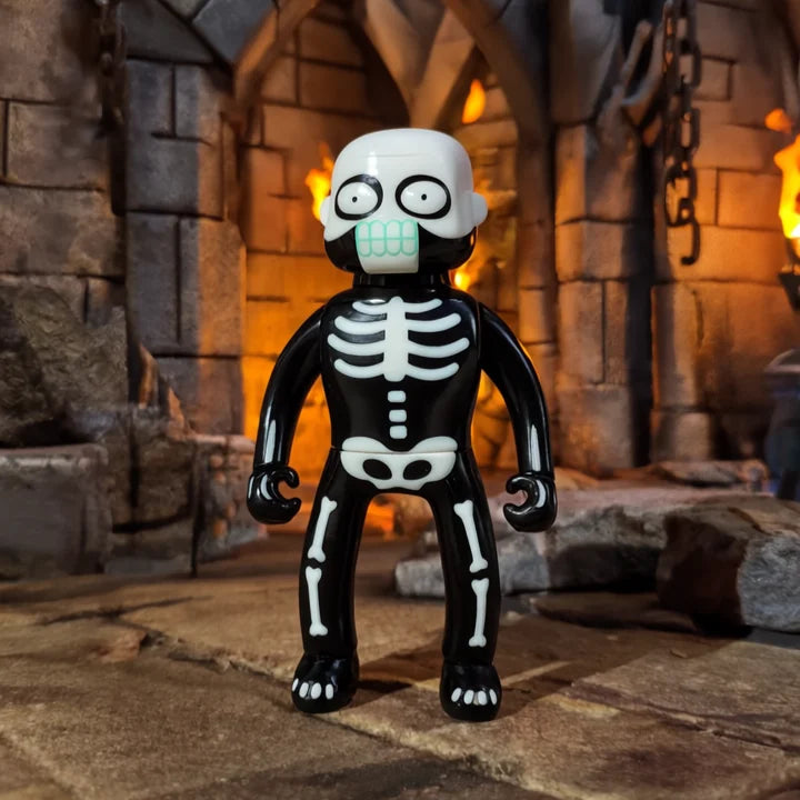 MR NOBODIES - SKELETON (GID GREEN) toy in a spooky dungeon setting, featuring skeleton-style print and skull head, perfect for collectors.