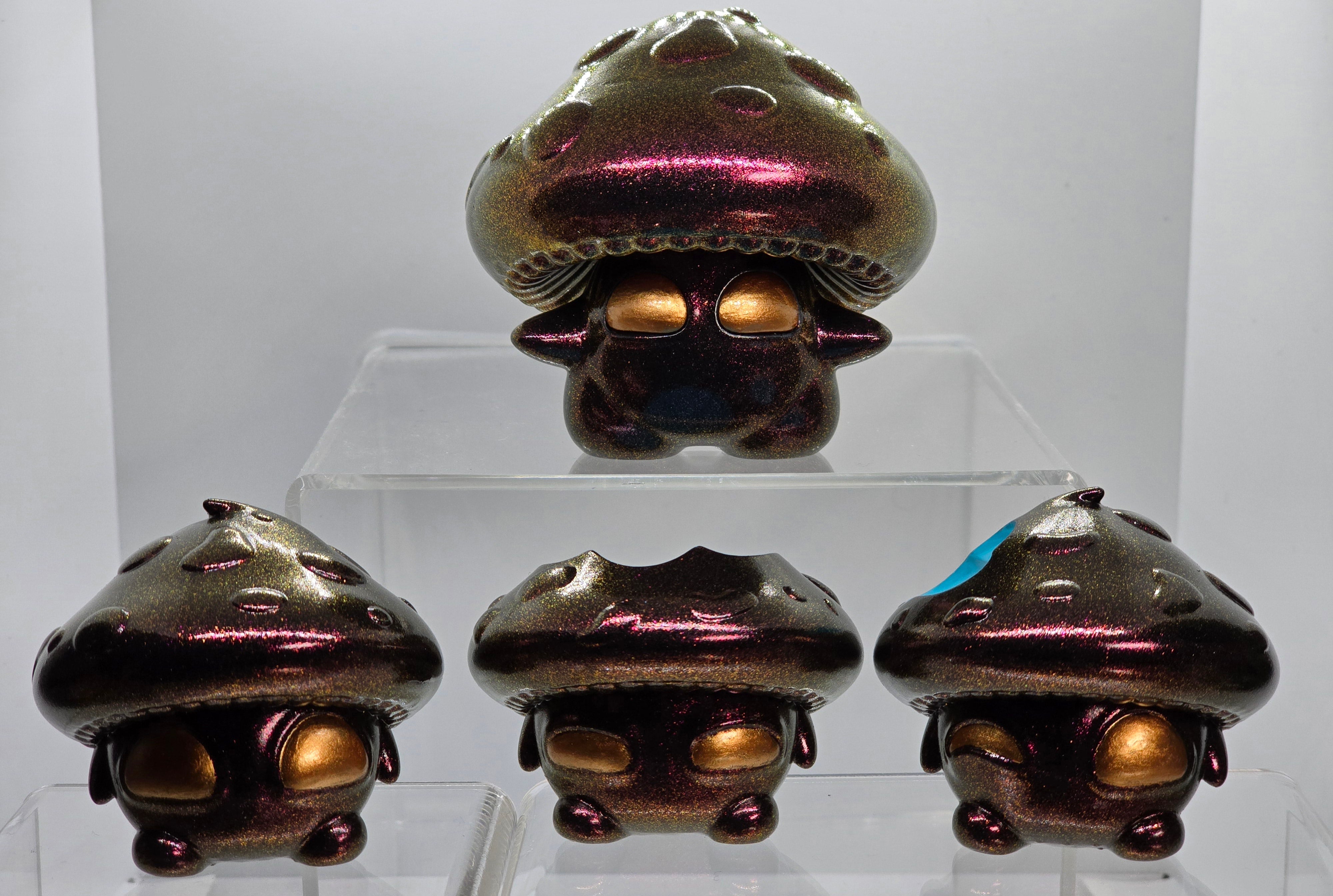 Bite Me - Bites by Neff's Nexus: A group of epoxy resin and acrylic paint shiny mushroom-shaped figurines on display, embodying unique art toy design.