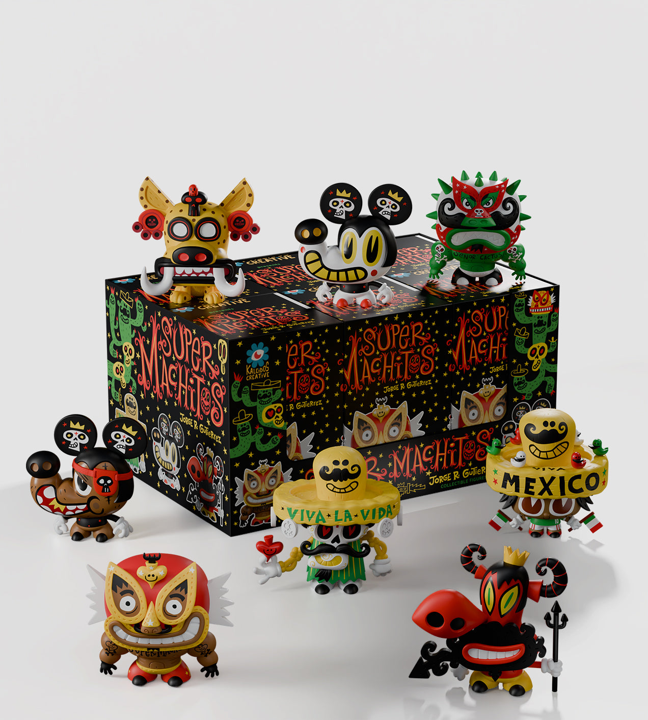Super Machitos Blind Box figures with Day-of-the-Dead motifs, featuring sombreros, cactus armor, and masks, arranged creatively around a decorated matching box.