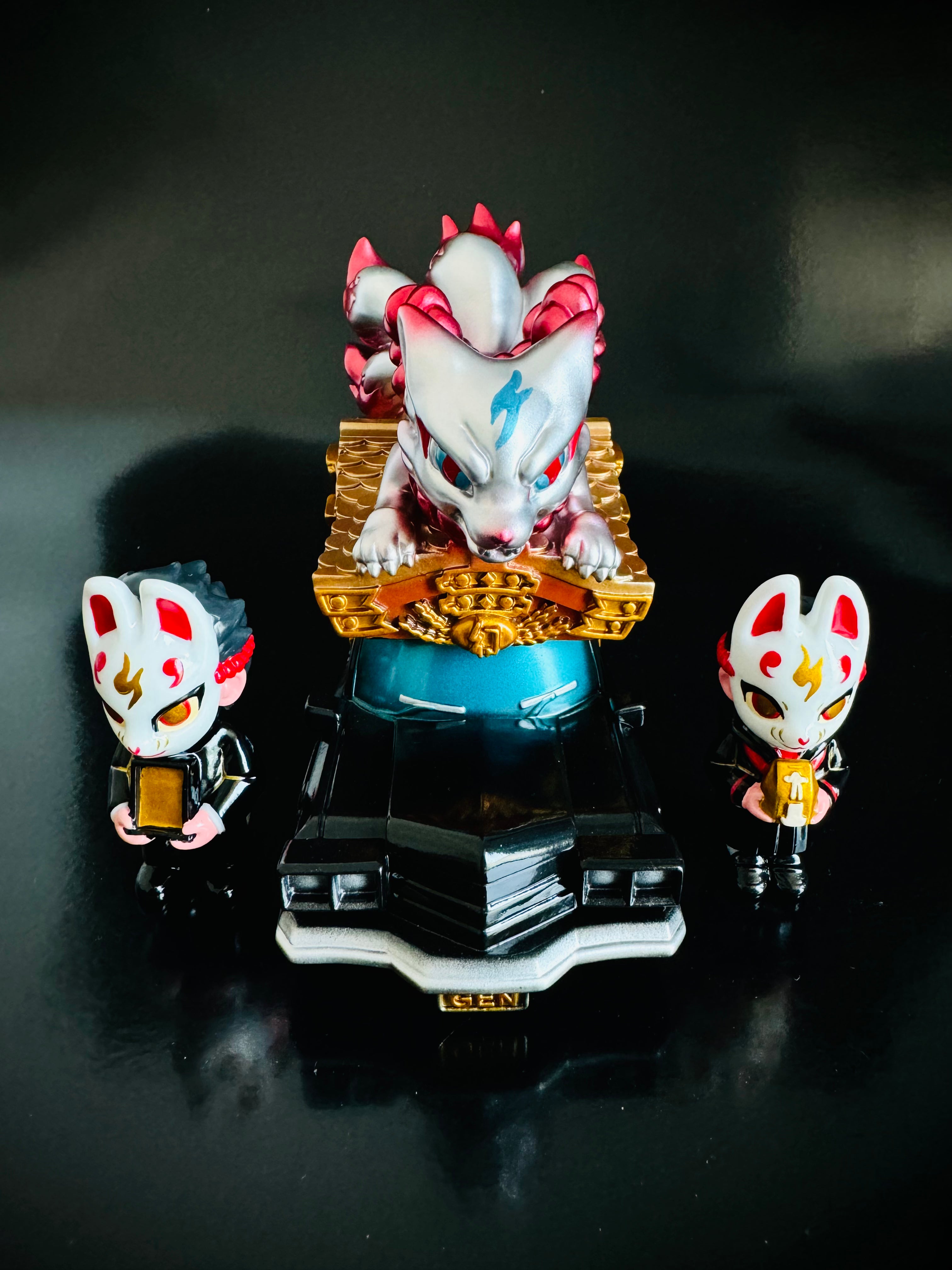 A blind box and art toy store's Genkosha Catafalque Set No 2: Golden & silver luxury car delivering a coffin, fox boy and girl figurines, and an openable coffin.