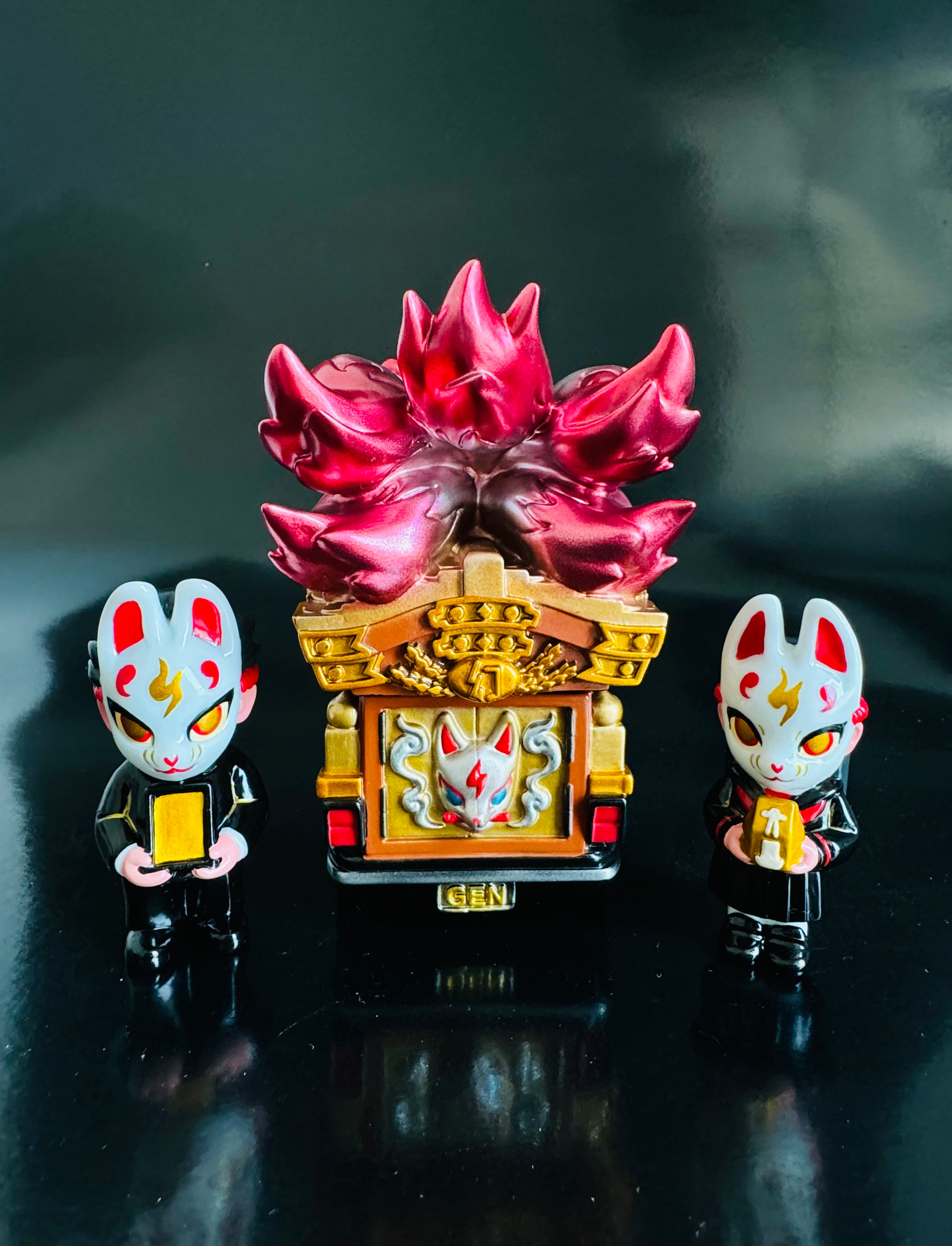A blind box set from Strangecat Toys: The Genkosha Catafalque Set No 2 featuring a luxury car delivering a coffin, fox boy and girl figurines, and an openable coffin.