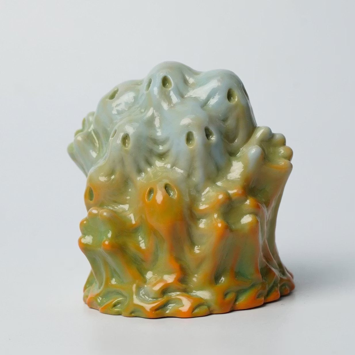 Retroband & Zectron's WHO GOES THERE? VERSUS features a glossy green abstract figure with tiny ghostly faces, crafted from soft vinyl, approximately 6cm tall.