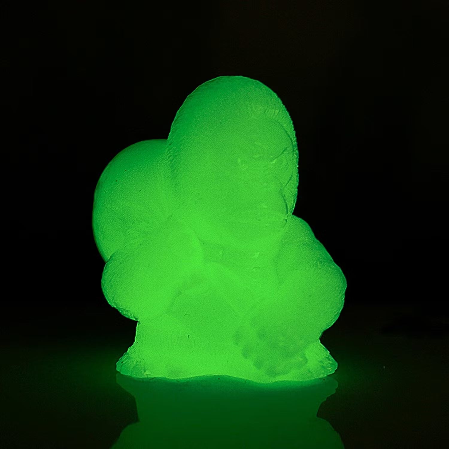 Retroband & Zectron's WHO GOES THERE? VERSUS Blind Box Series toy, glowing neon-green on a reflective surface, showcasing its unique, amorphous design.