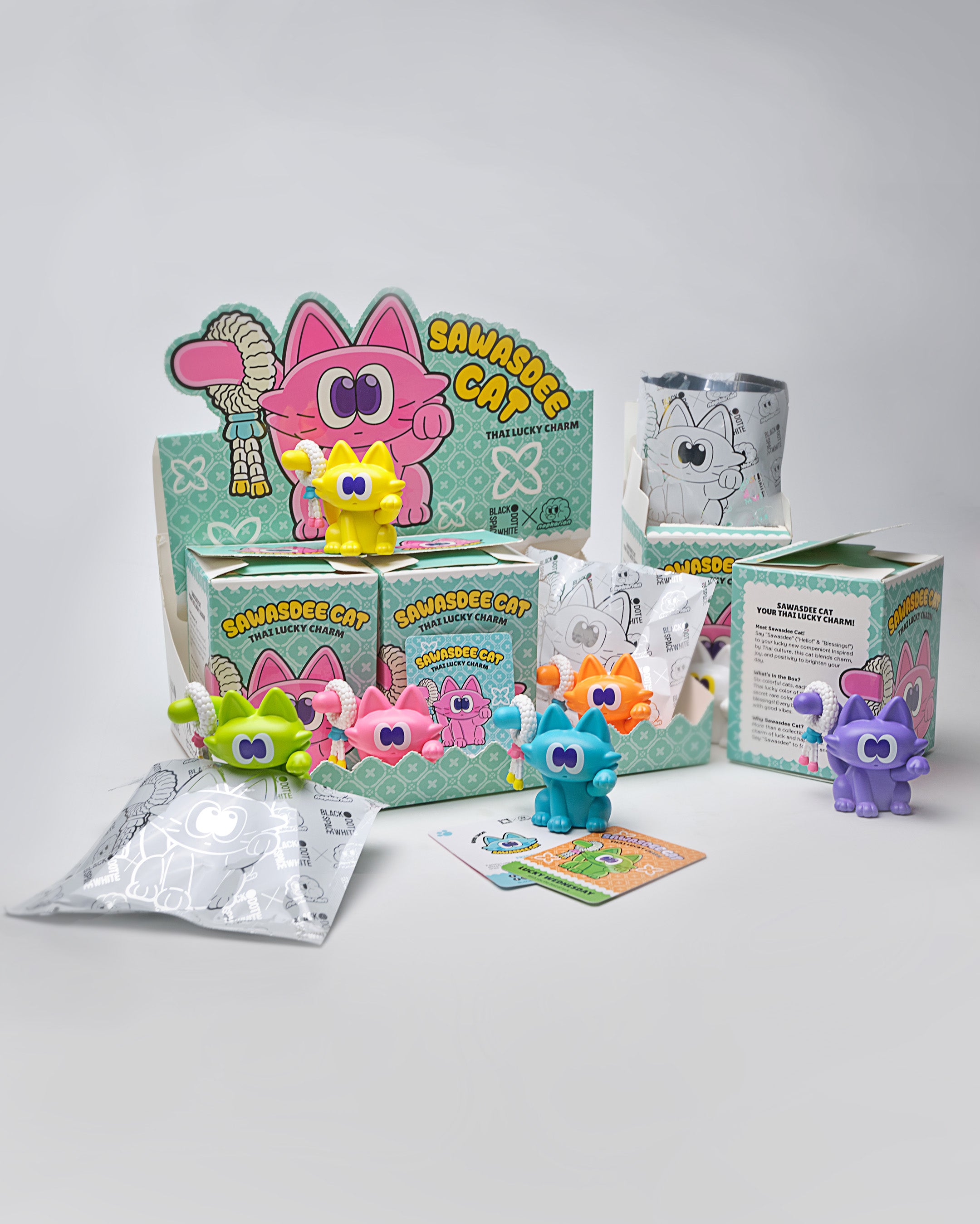 Sawasdee Cat Blind Box Series featuring cat figurines and a silver bag with a cartoon character, offering a mix of regular and secret designs.