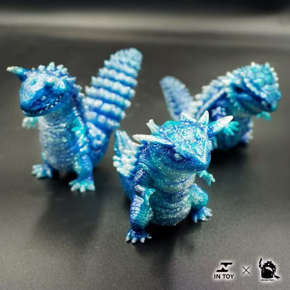 Mini Ultra Beast sofubi - shine .Ver collectible vinyl figures, glittery turquoise-blue dragons with movable parts, part of a designer-toy collaboration by IN TOY and Monster Hero.
