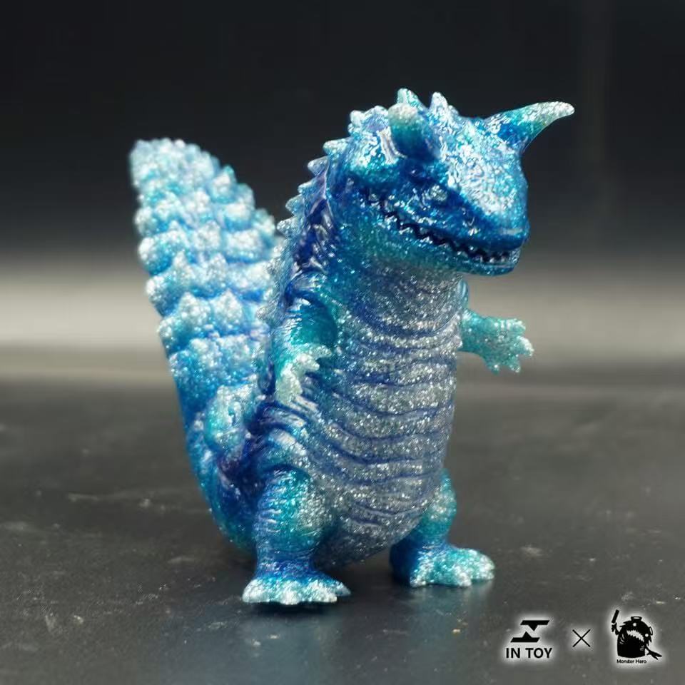 Mini Ultra Beast sofubi - shine .Ver collectible toy, translucent blue with glitter, ridged body, horn, and movable parts; part of IN TOY × Monster Hero collaboration.