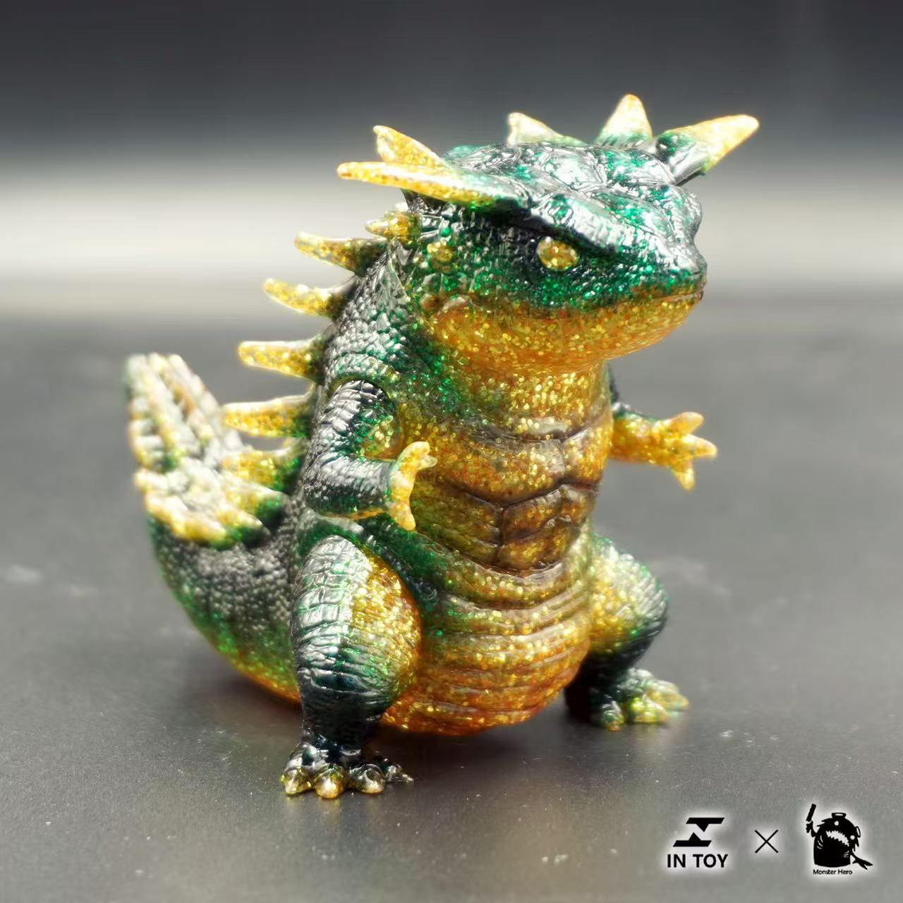 Mini Ultra Beast sofubi - brilliance .Ver - Preorder: A small, chubby vinyl monster figurine with movable parts, featuring spiky details and collectible logos.