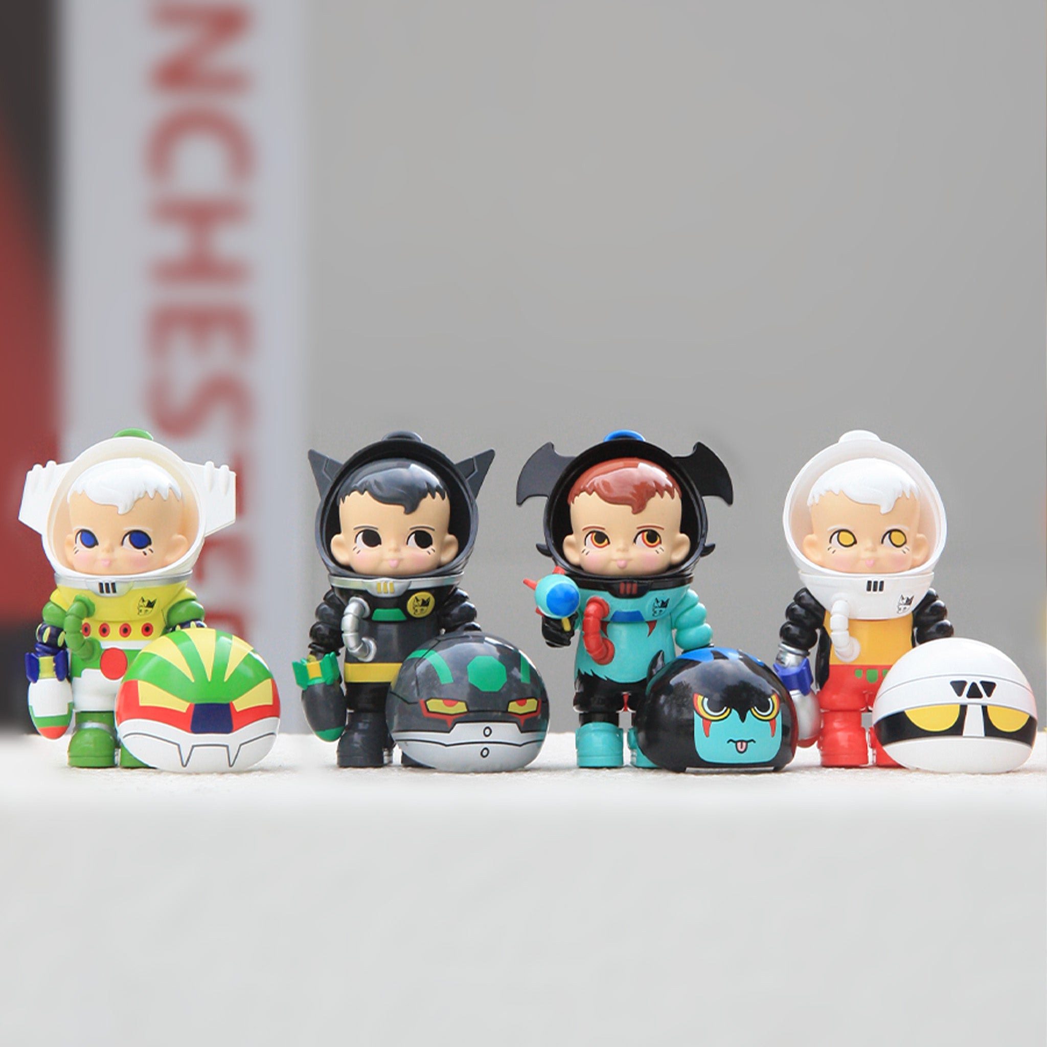 SAMSAM ADVENTURER X GO NAGAI BLIND BOX: Four stylized vinyl figures in space suits with swappable helmets, showcasing unique designs.