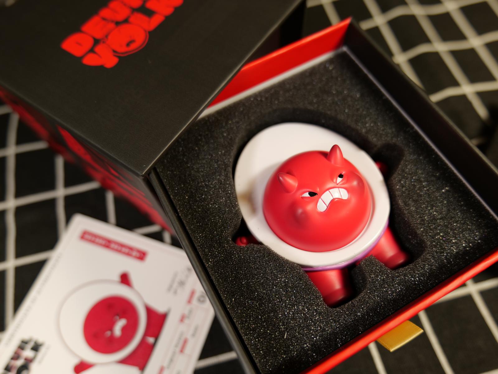 Devil Yolk by Rama Rama - Preorder, a toy in a box, with a foam container, and a button close-up, limited 50pcs.