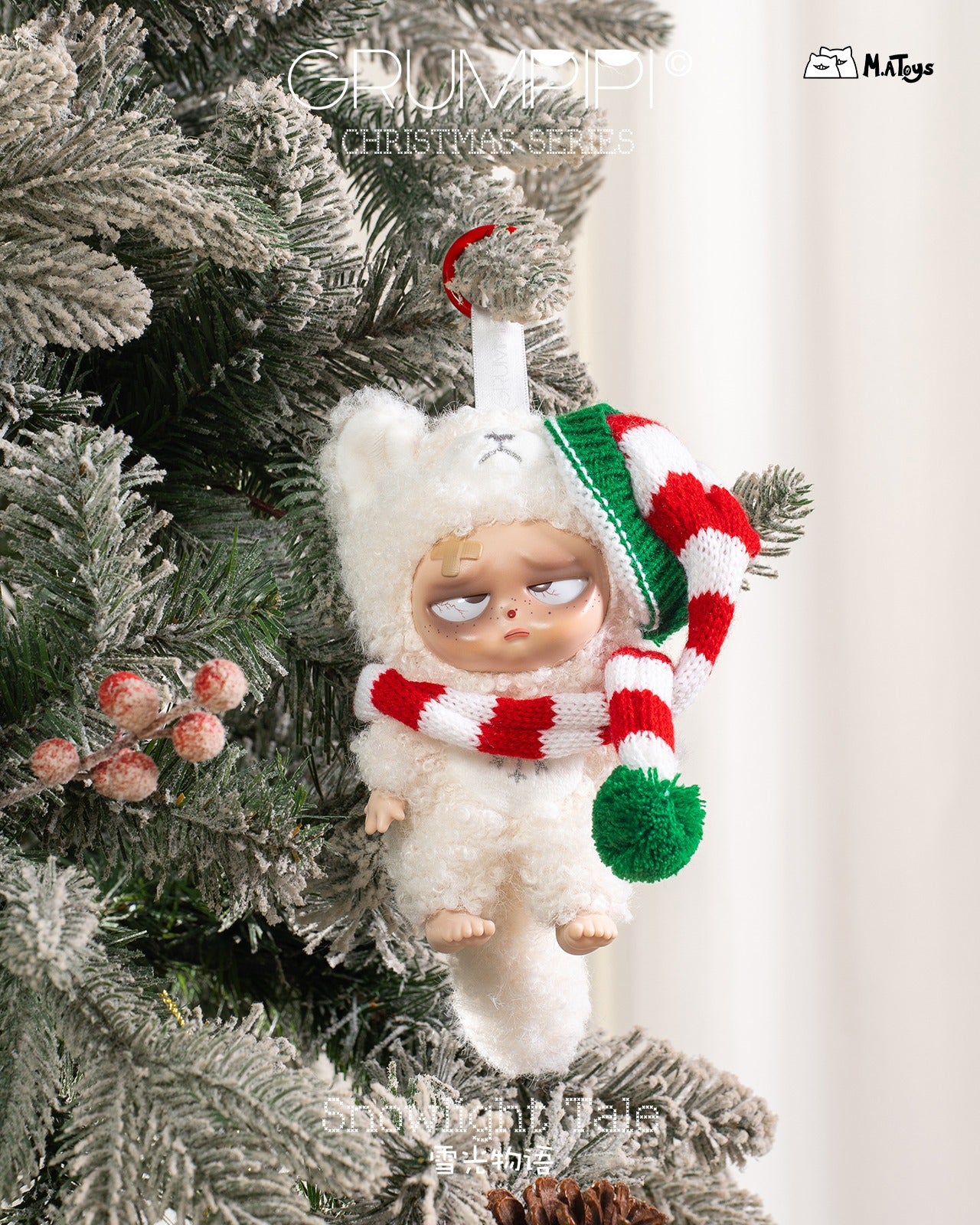 Sleepless Grumpipi Christmas Plush Keychain: a grumpy doll in a bear suit with a striped scarf and hat, hanging on a snow-dusted evergreen branch.