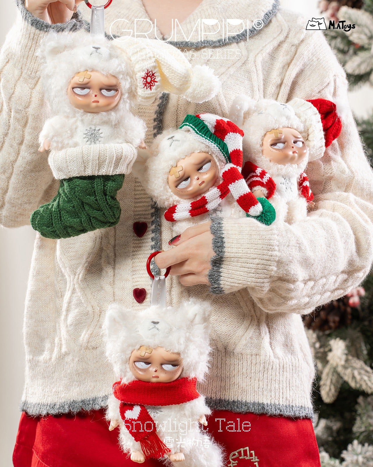 Person holding four Sleepless Grumpipi Christmas Plush Blind Box Keychains, featuring scowling faces in winter costumes, with a Christmas tree faintly visible behind.