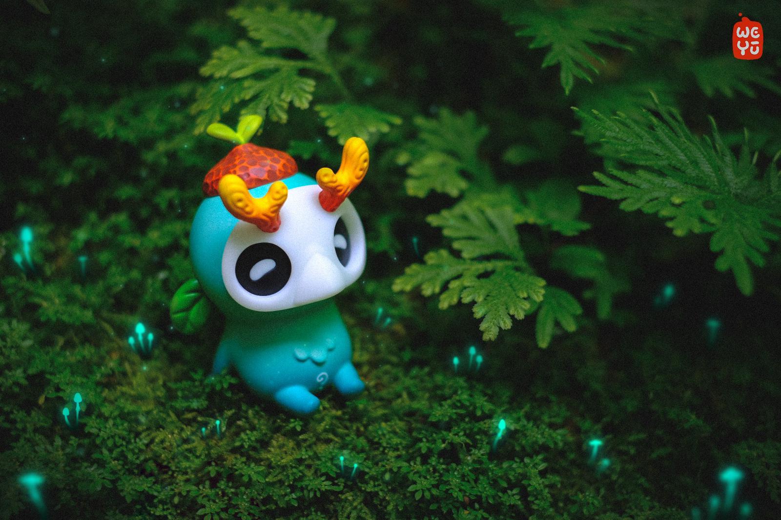 Ori muffinn by Madkids, a teal creature figure with orange horns and a mushroom cap, sits on moss surrounded by glowing mushrooms, creating an enchanted forest vibe.