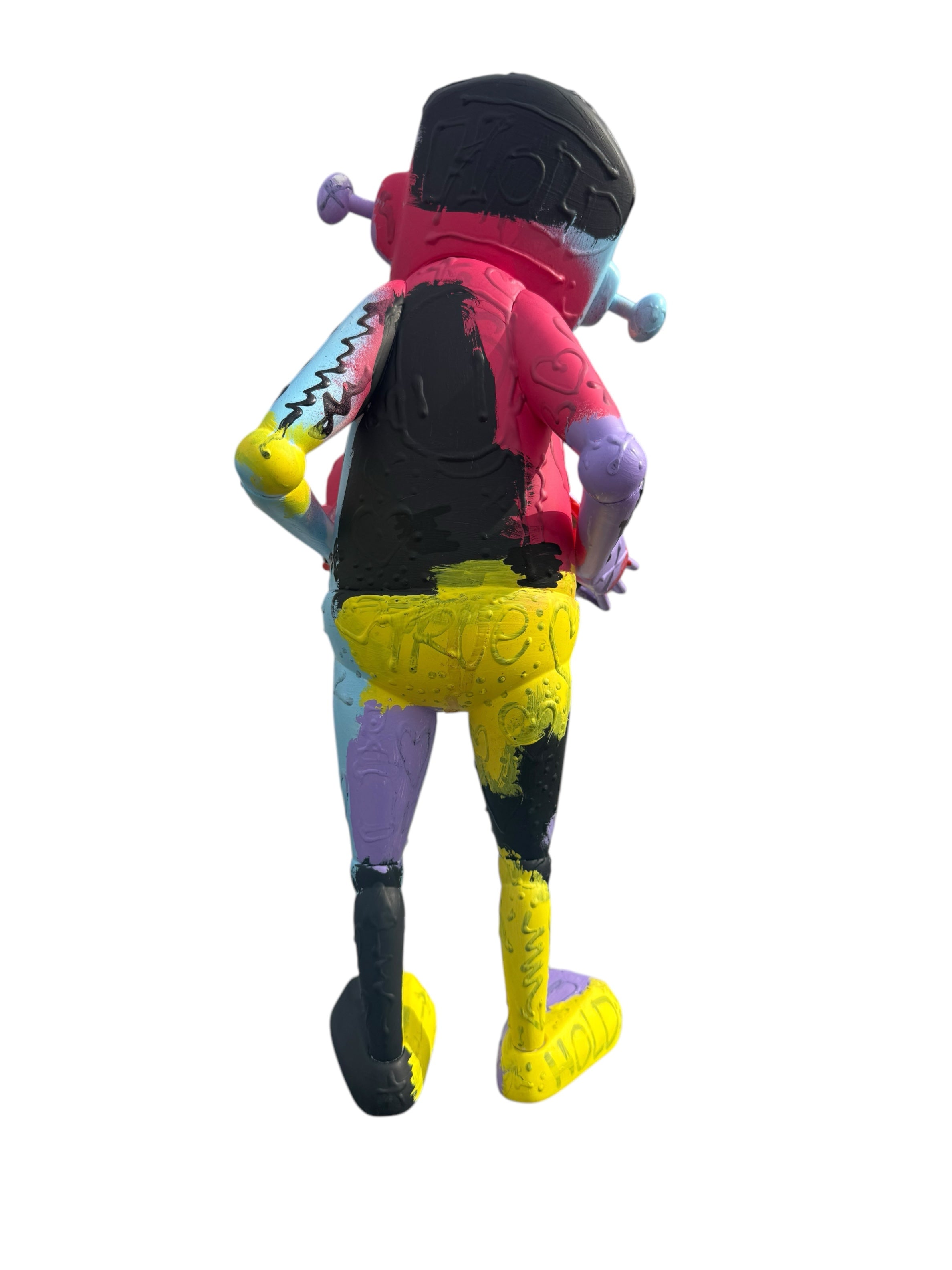 Back view of 'Time Will Tell - Where the smiles have been' by Chris RWK, a 15-inch limited-edition vinyl figure with graffiti-style scribbles and bright paint.
