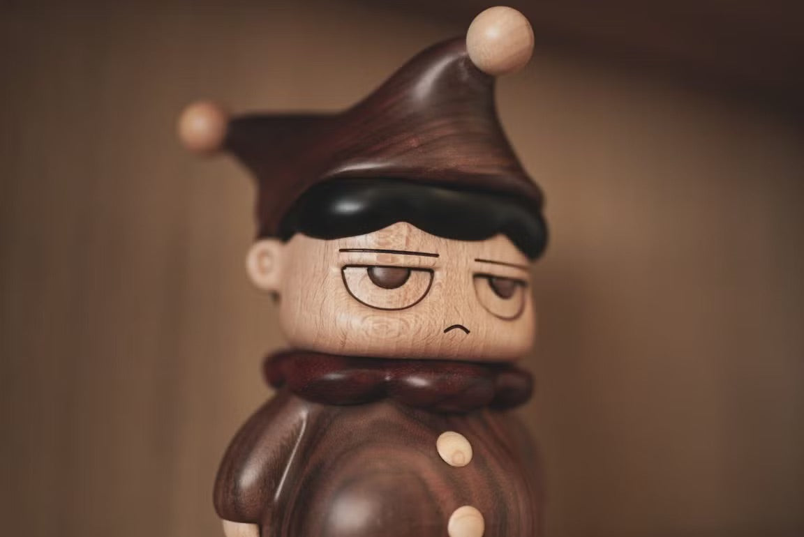 POH Wood by Vin: A 21cm wooden figurine depicting a sad-faced man, ideal for art toy collectors.