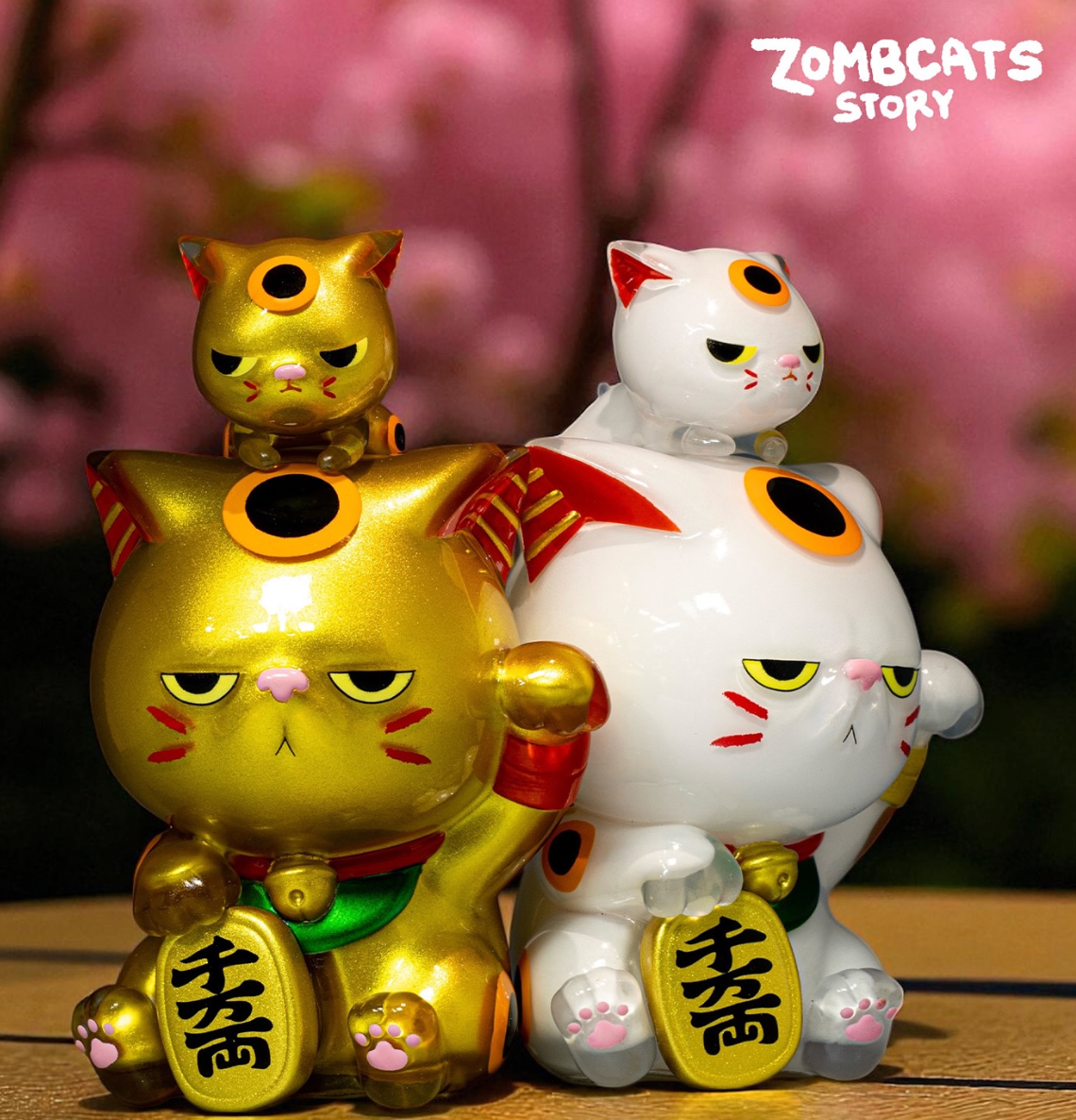 Zombcats Story - Grumpy Maneki LOTTERY features stylized vinyl lucky cat figurines with miniature versions on their heads, holding yen-style tokens.