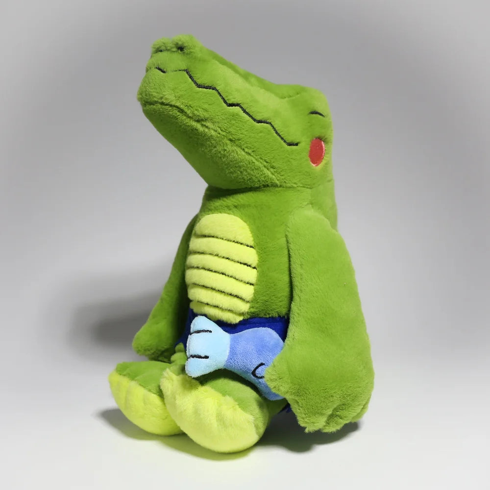 Monkay + Alligator Plush by Life Machine: A green plush crocodile with a yellow belly, holding a small blue fish, featuring magnetic hands.