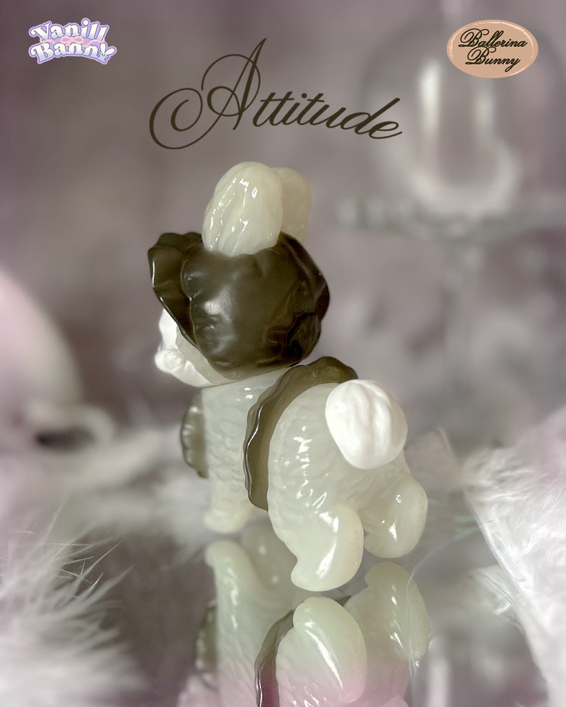 Vanill Bunny - Ballerina Bunny by Ms LUTRA, a 130mm sofubi collectible, stands on a mirrored surface, showcasing its pearly translucent design with brown accents.