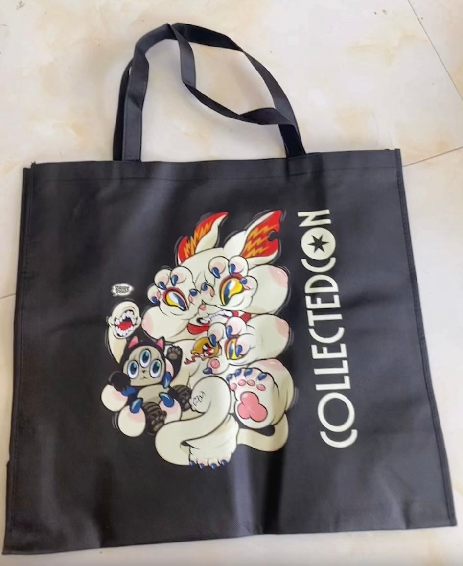 CC Bag featuring a multi-eyed creature illustration and COLLECTEDCON text. Available for preorder, ships August 2025.