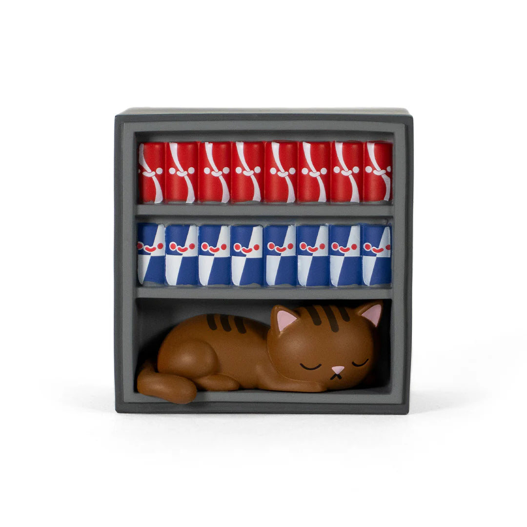 Bodega Kitties Mystery Series 2 Boxes by 100% Soft displayed with colorful cylinders and a tabby cat figurine in a gray shelving unit.