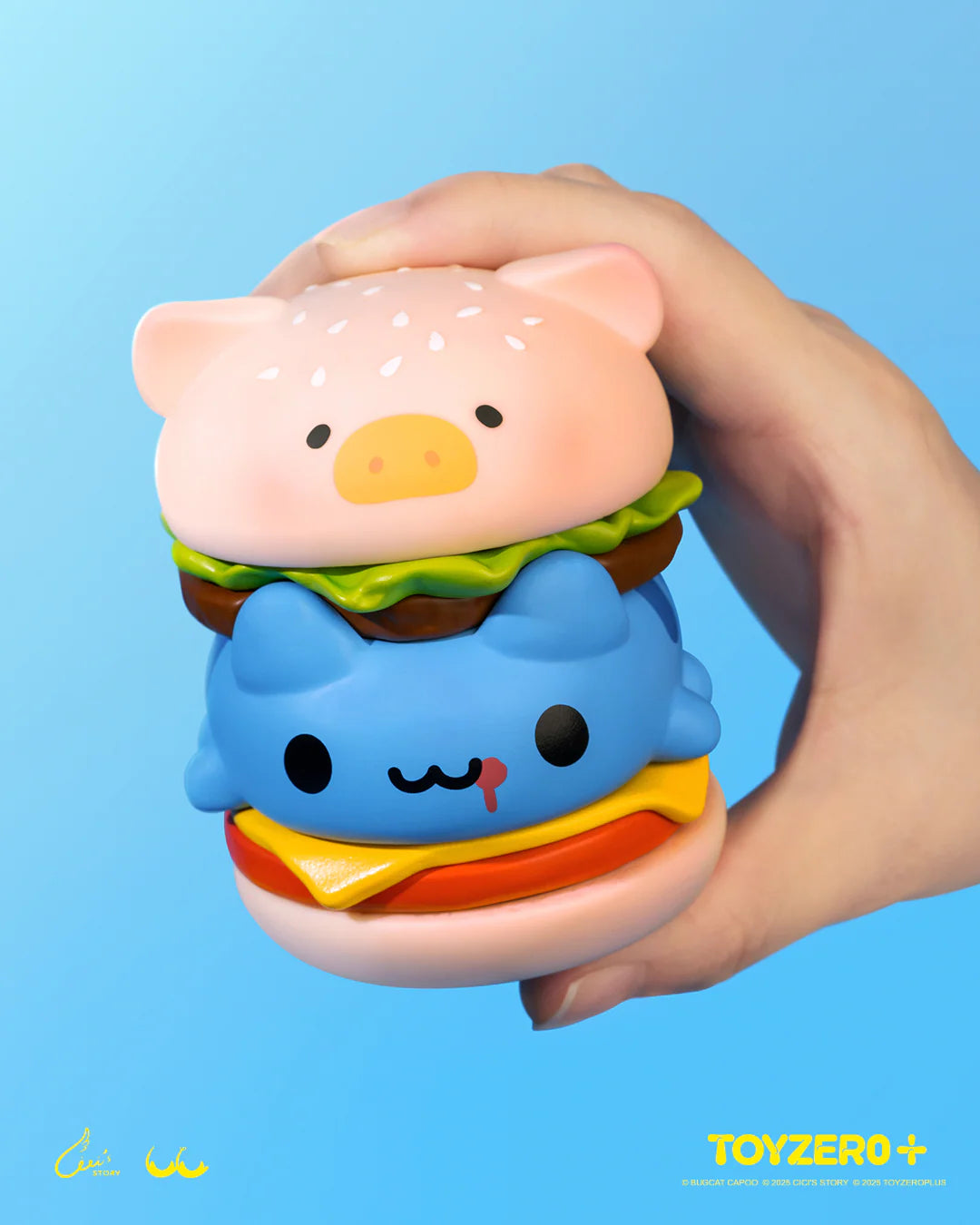 LuLu the Piggy x Capoo - LuLuBurger toy with detachable layers, featuring whimsical pig and cat faces, held against a light-blue backdrop.