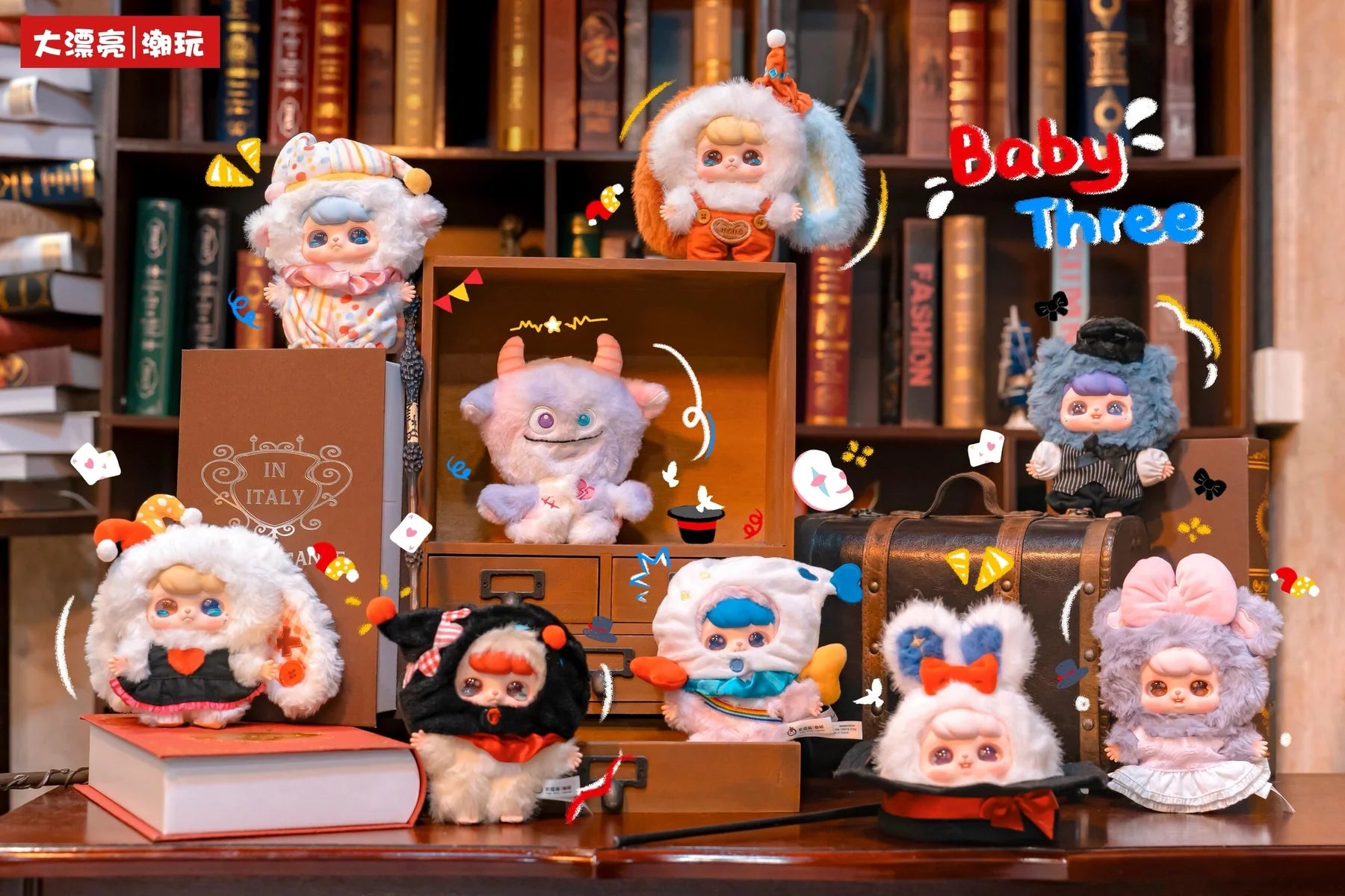 Nine kawaii Baby Three - Ave - Fantasy Circus Plush Blind Box dolls in animal costumes, including a monster with horns, displayed on a wooden desk.