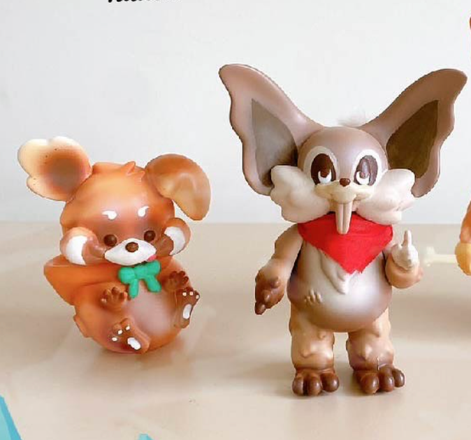 Thief Raccoons by Vivian Wang, featuring kawaii-style vinyl figures with exaggerated features: a red-panda-mouse hybrid and a fox-like creature, perfect for collectible art toy enthusiasts.